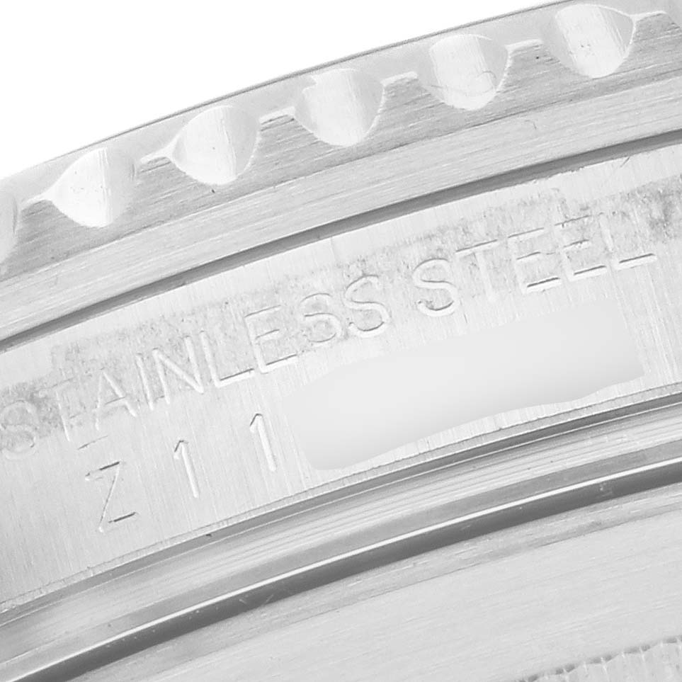 This close-up image shows the edge of the bezel and the engraved stainless steel case of a Rolex Submariner 16610 Men
s Stainless Steel Black Dial 16610 Men
s Stainless Steel Black Dial watch.