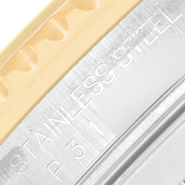 A macro shot of the Rolex Submariner 16613 Men's Steel and Gold (two tone) Black Dial 16613 Men's Steel and Gold (two tone) Black Dial bezel and case, showing the stainless steel engraving.