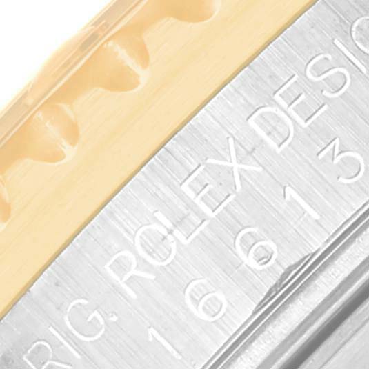 This close-up image shows the bezel and case side of a Rolex Submariner 16613 Men's Steel and Gold (two tone) Black Dial 16613 Men's Steel and Gold (two tone) Black Dial, displaying part of the model number and brand engraving.