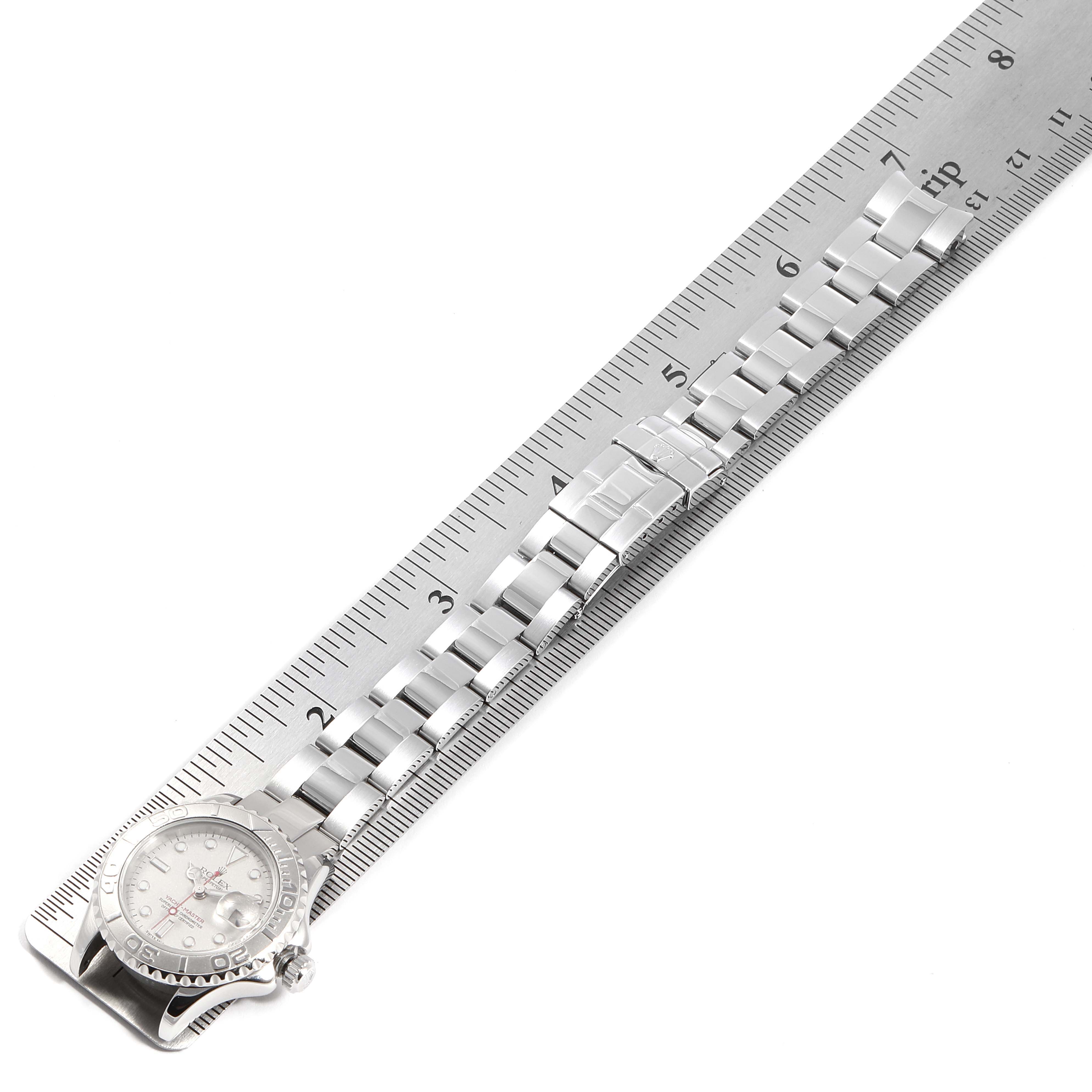 The image shows a Rolex Yacht-Master 169622 Women's Stainless Steel Silver Dial 169622 Women's Stainless Steel Silver Dial watch laid flat alongside a ruler, displaying the dial, bezel, bracelet, and clasp.