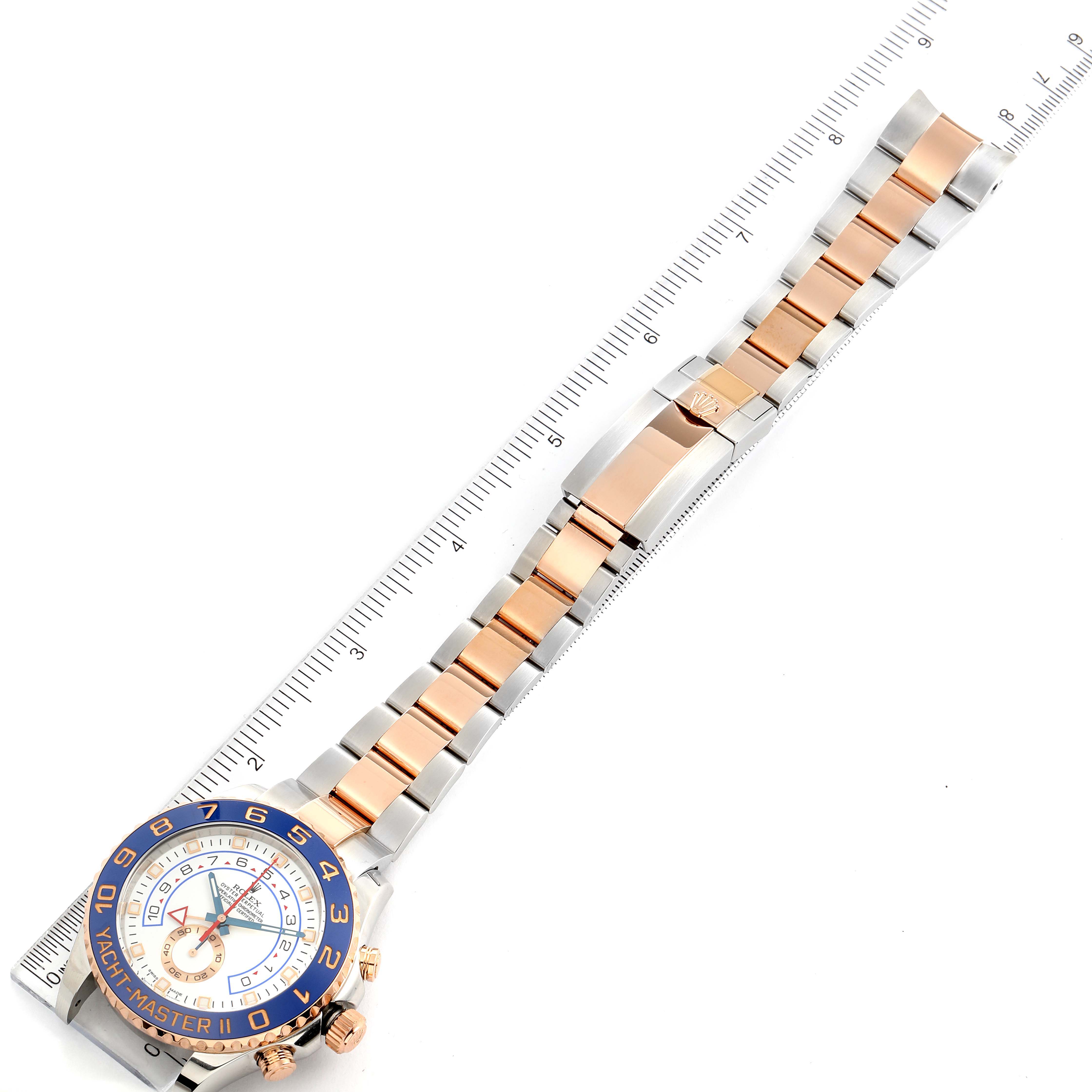 The image shows a top-down view of a Rolex Yacht-Master 116681 Men's Steel and Gold (two tone) White Dial 116681 Men's Steel and Gold (two tone) White Dial watch, detailing the watch face, bezel, bracelet, and clasp.