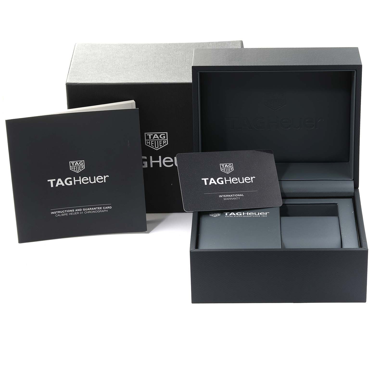 The image shows an open Tag Heuer Carrera CAR2090 Men's Stainless Steel Black Dial CAR2090 Men's Stainless Steel Black Dial watch box with an instruction manual and warranty card displayed beside it.