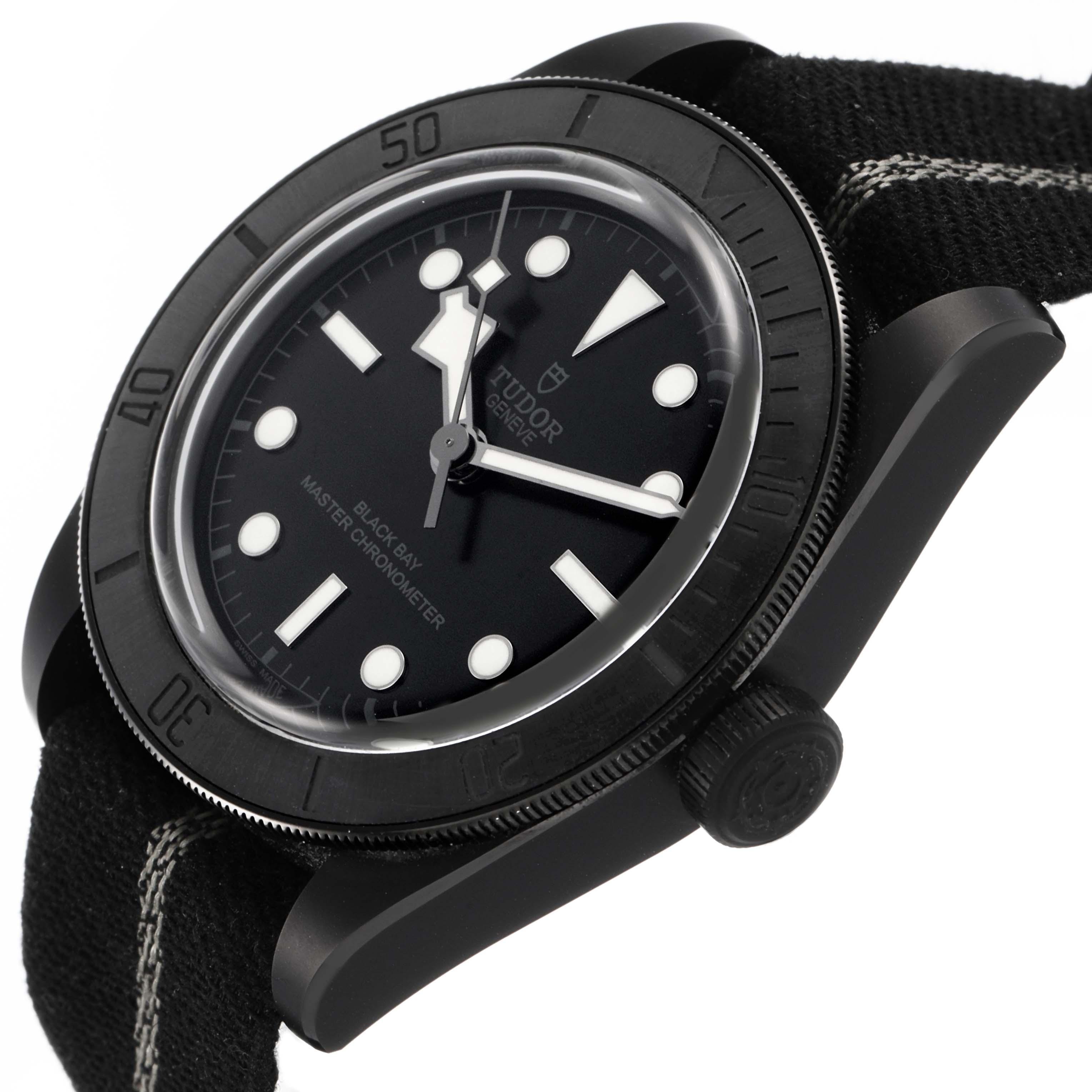 The image shows a side angle of the Tudor Heritage Black Bay M79210CNU Men's Ceramic Black Dial watch, highlighting the dial, bezel, and strap.