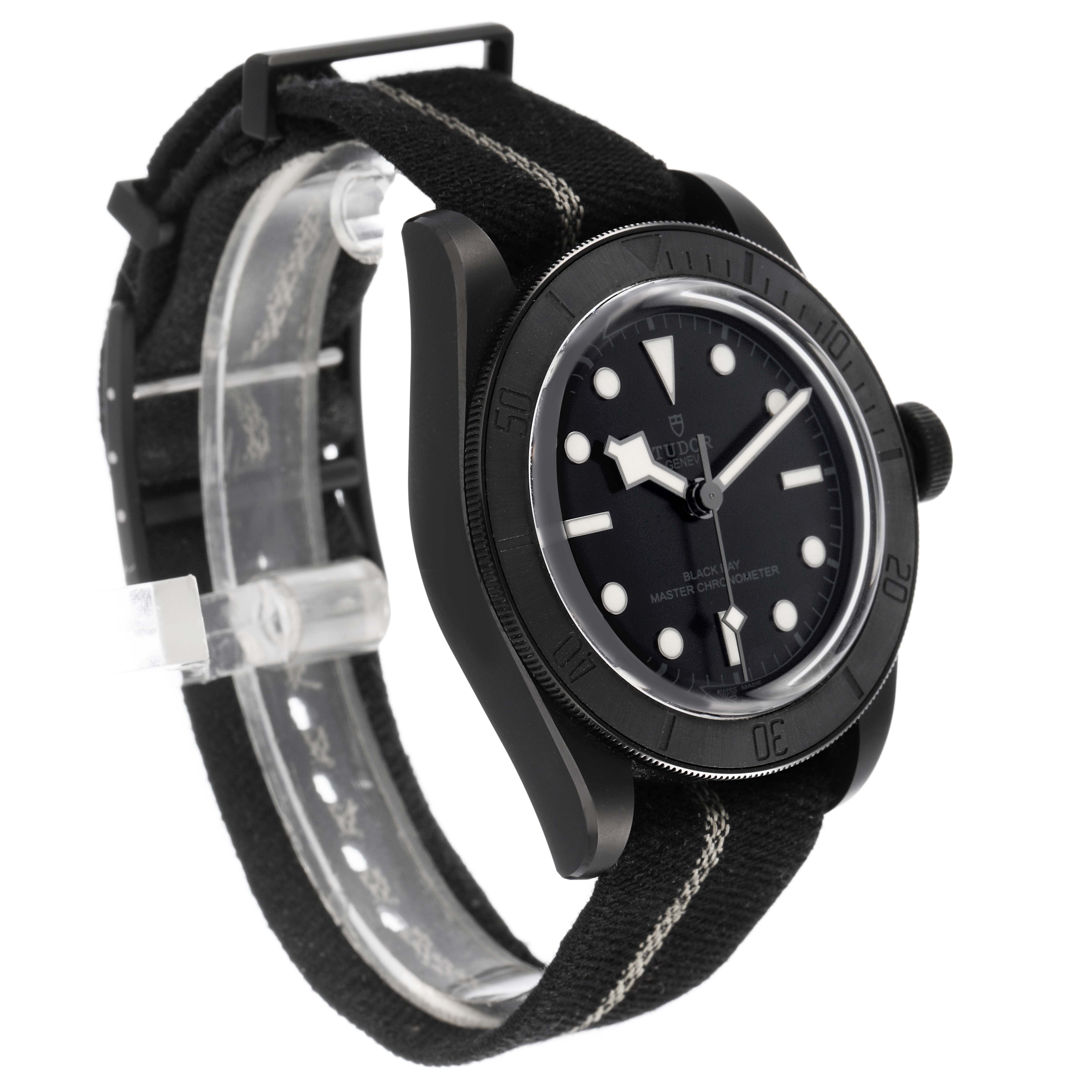 The Tudor Heritage Black Bay M79210CNU Men's Ceramic Black Dial watch is shown at a three-quarter angle, displaying the case, bezel, dial, and strap.