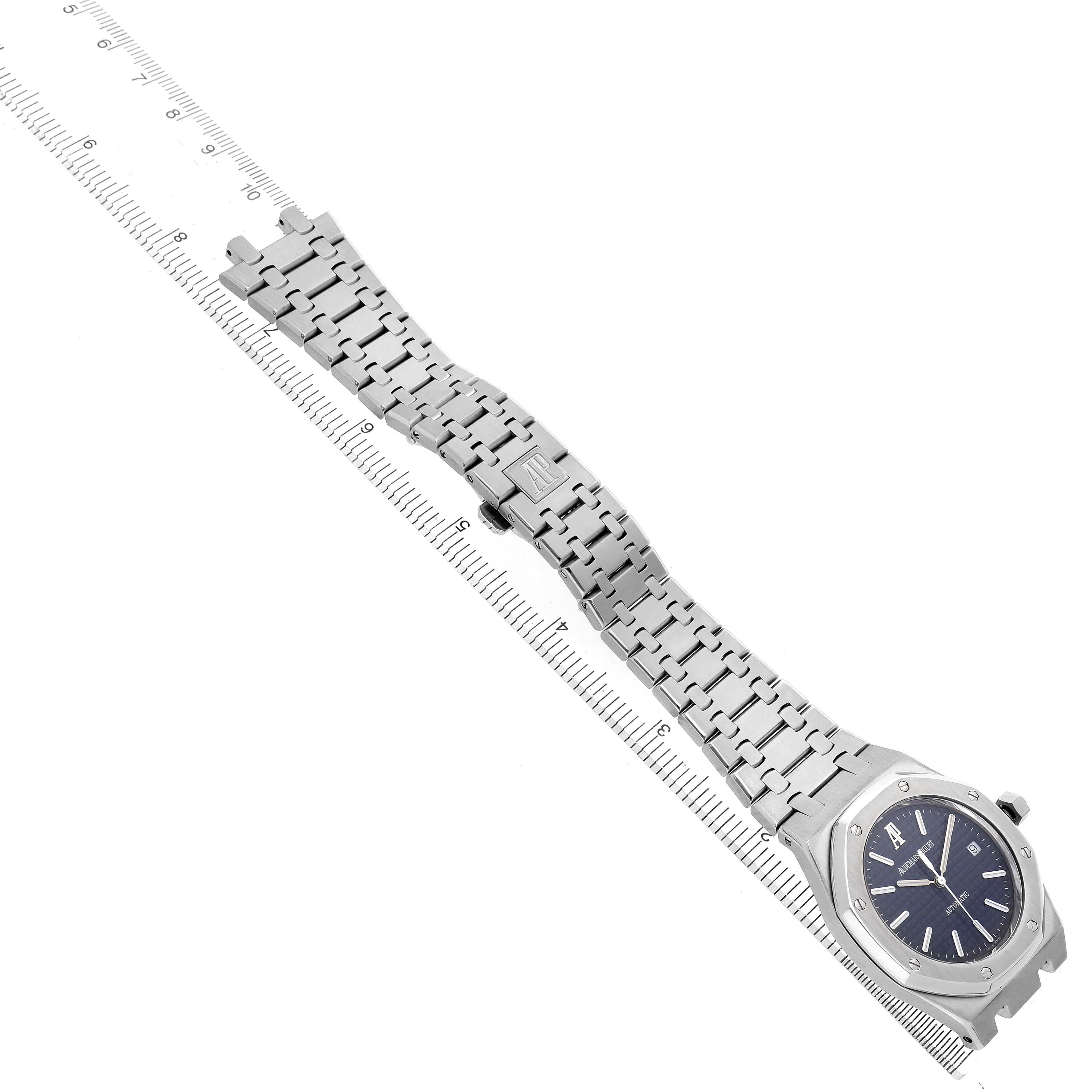 The Audemars Piguet Royal Oak 83220 Men's Stainless Steel Blue Dial watch is displayed diagonally, showing the full face, bezel, bracelet, and clasp with a ruler underneath.