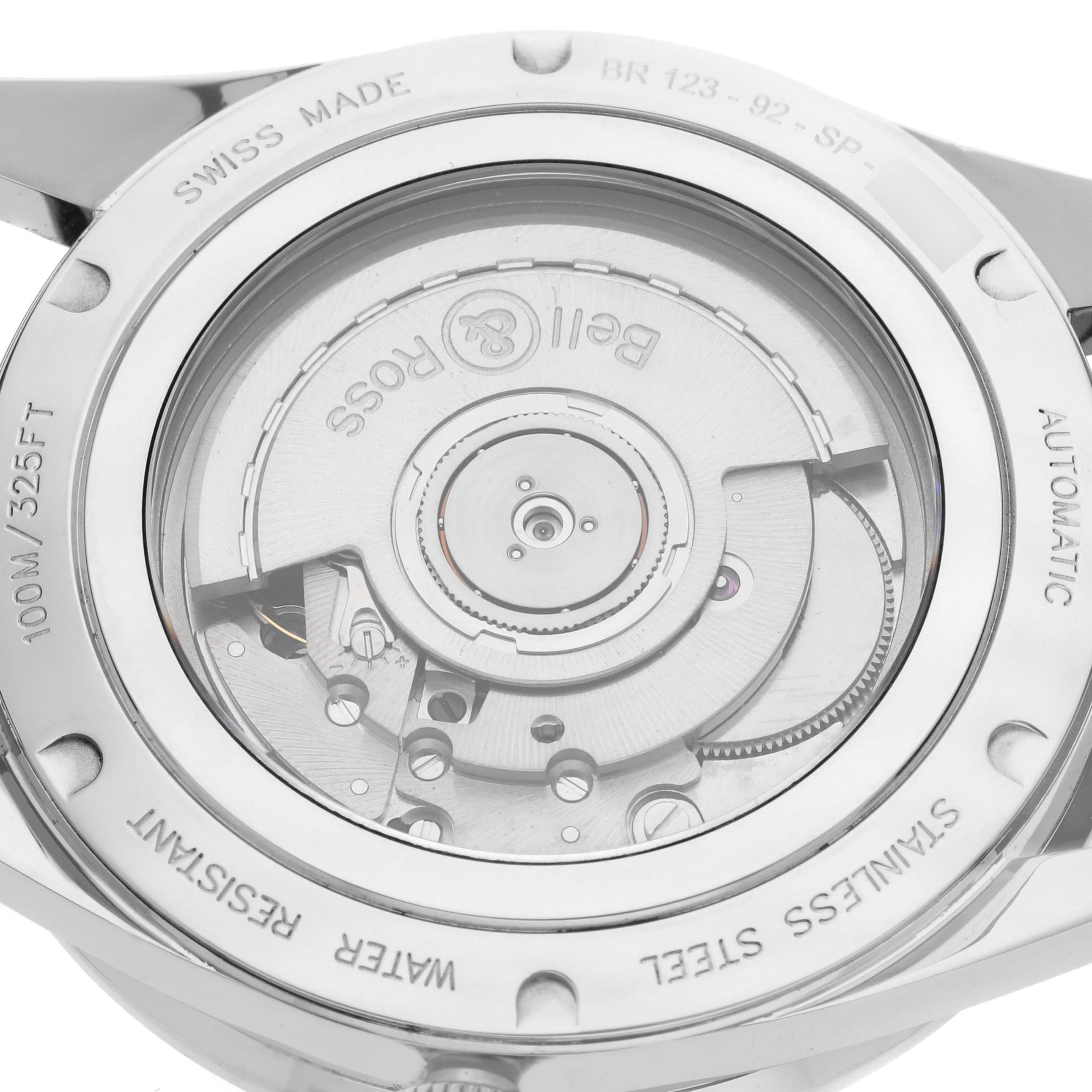 The image shows the back case of the Bell 
Ross Heritage BR 123-92-SP Men
s Stainless Steel Black Dial BR 123-92-SP Men
s Stainless Steel Black Dial BR 123 watch, highlighting its automatic movement.