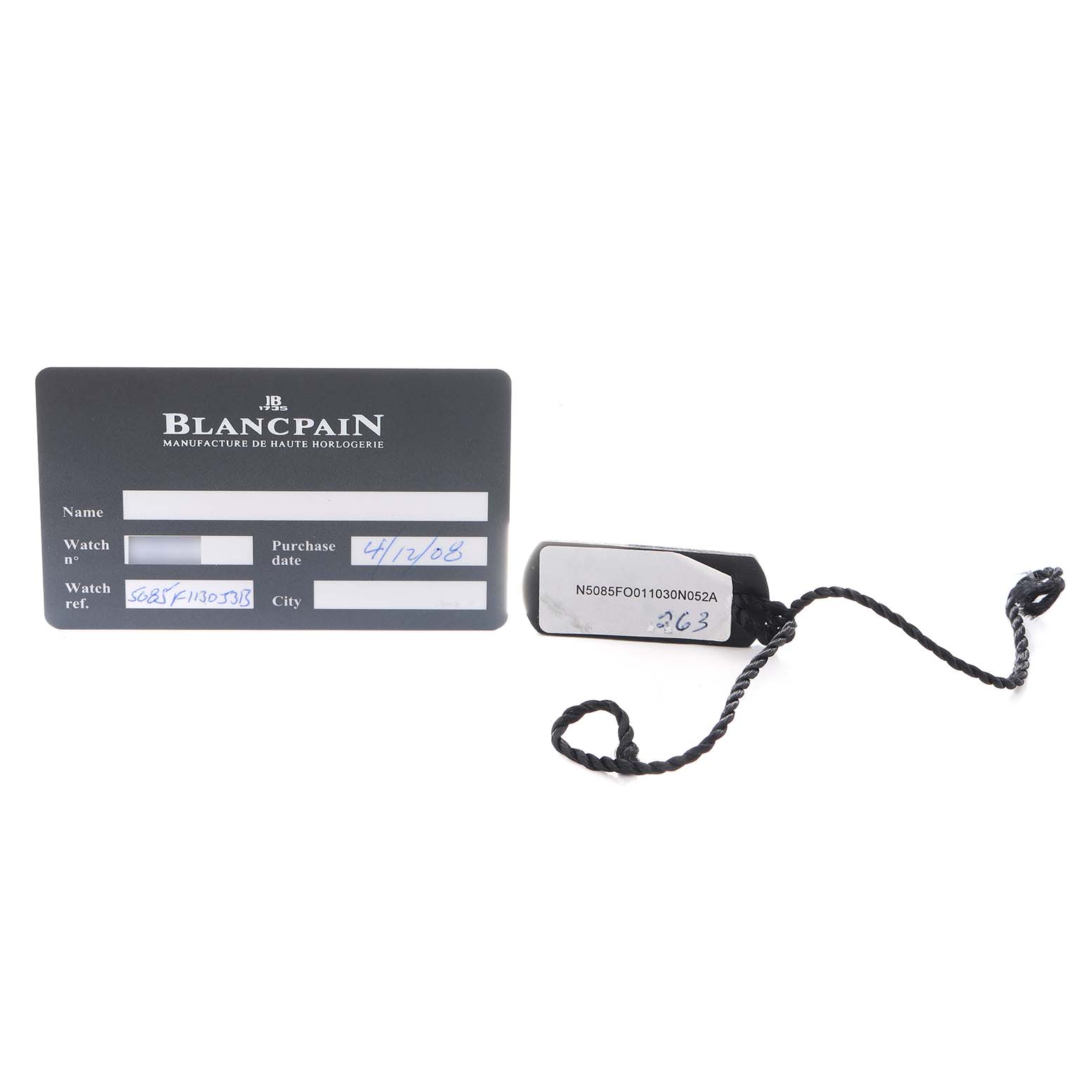 This image shows a Blancpain Fifty Fathoms 5085F-1130-J313 Men
s Stainless Steel Black Dial warranty card and a black tag with a braided string.