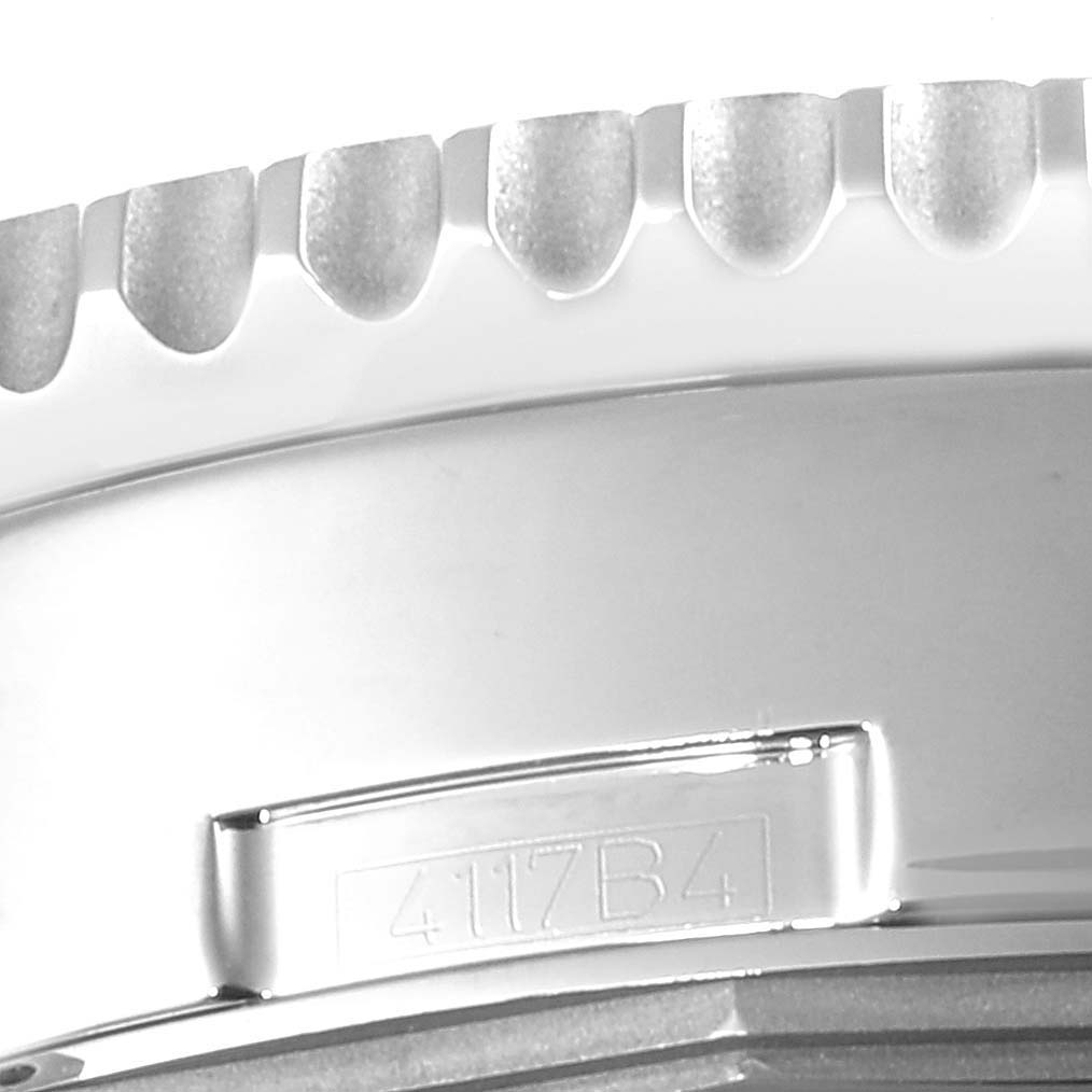 The image shows a close-up of the bezel and case side of a Breitling Navitimer AB012721-C889-453A Men's Stainless Steel Blue Dial AB012721-C889-453A Men's Stainless Steel Blue Dial watch, highlighting its ridged edge and reference number.