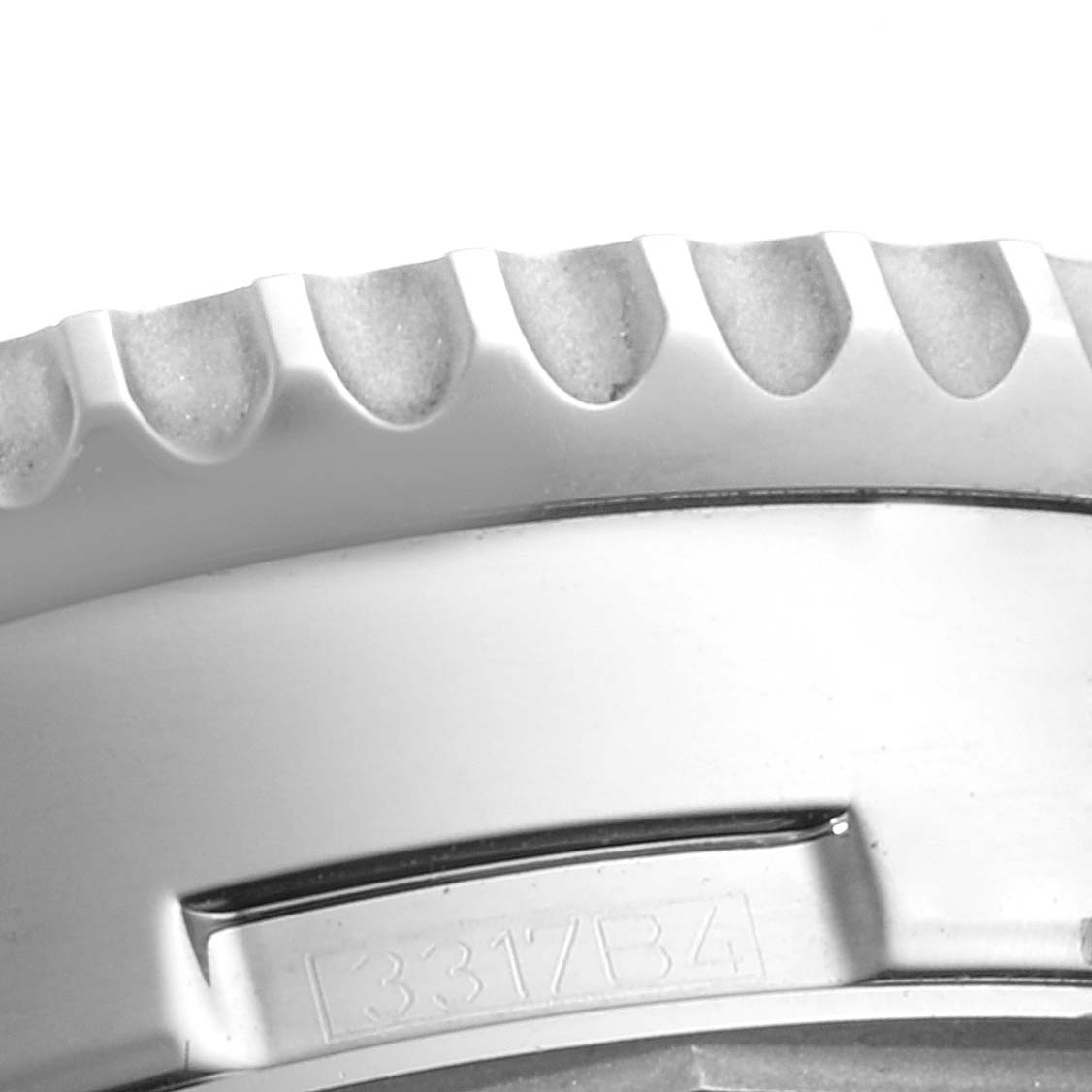 This image shows a close-up angle of the bezel of a Breitling Navitimer AB0127-211-B1A1 Men
s Stainless Steel Black Dial AB0127-211-B1A1 Men
s Stainless Steel Black Dial watch, displaying its serrated edge and part of the case.