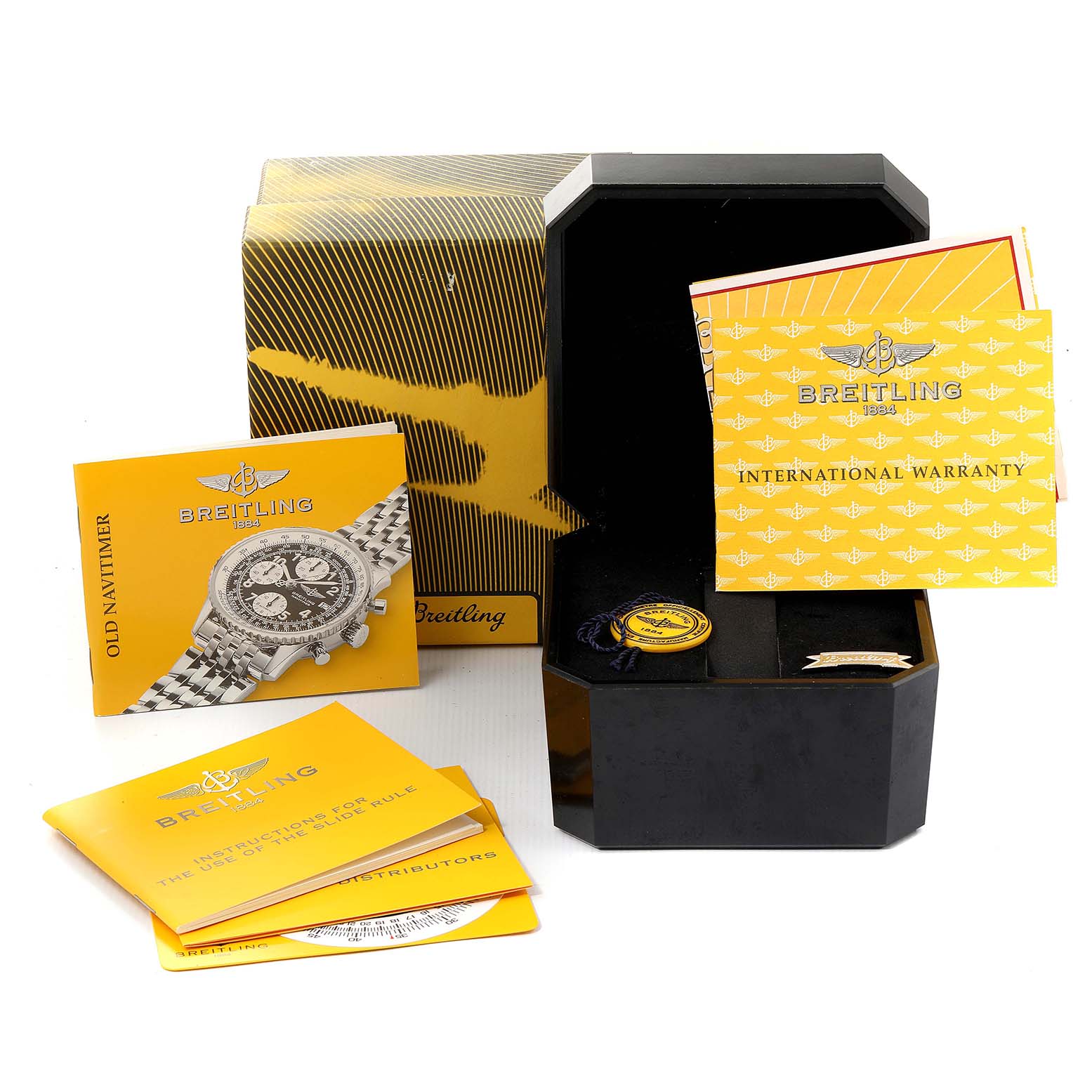 The image shows accessories for a Breitling Navitimer A13322 Men
s Stainless Steel Black Dial A13322 Men
s Stainless Steel Black Dial watch, including its box, manuals, warranty card, and tags.