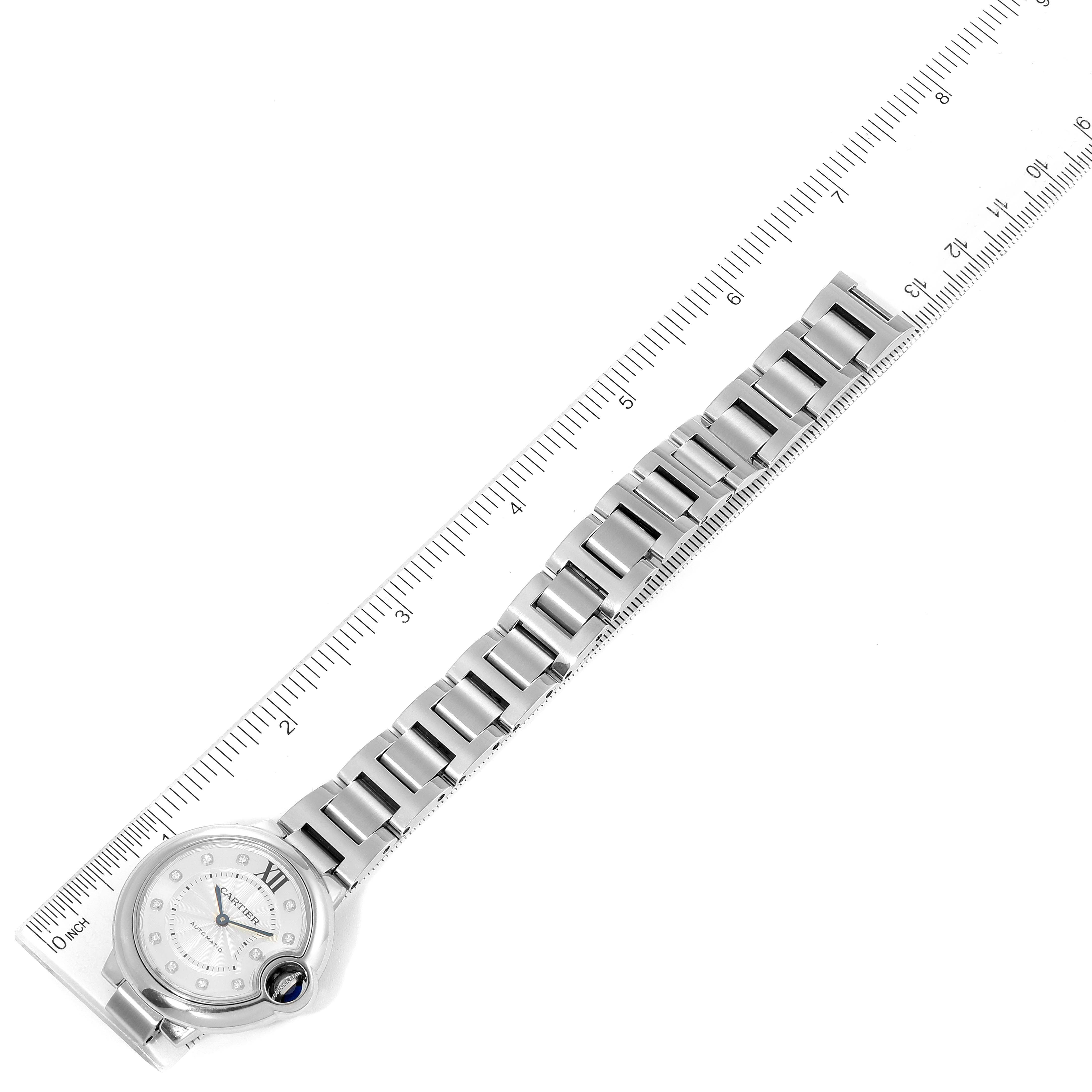 The image shows the Ballon Bleu de Cartier watch at an angle, highlighting the watch face, bracelet, and a ruler for measurement.