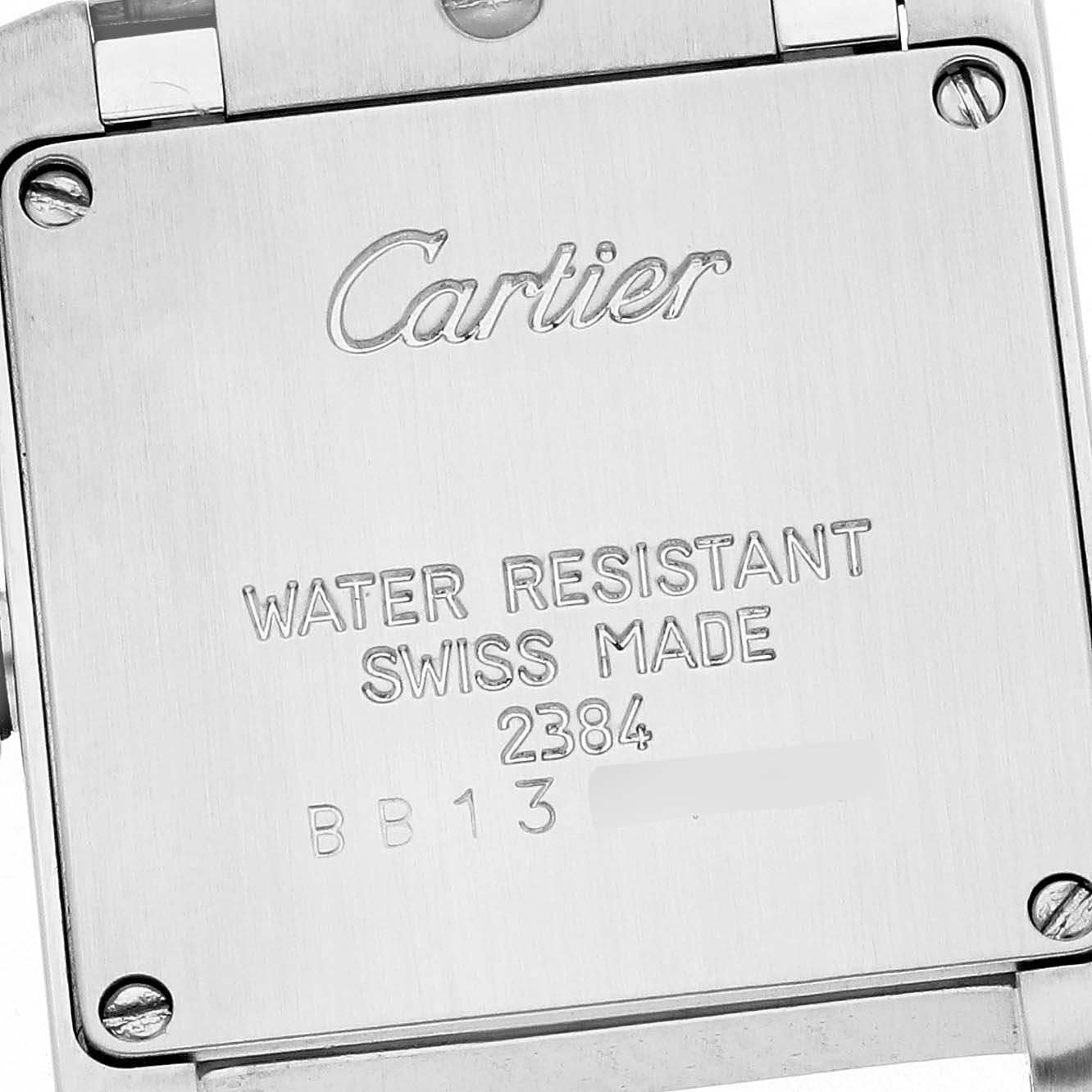 The image shows the back of a Tank Française model by Cartier, highlighting engravings.