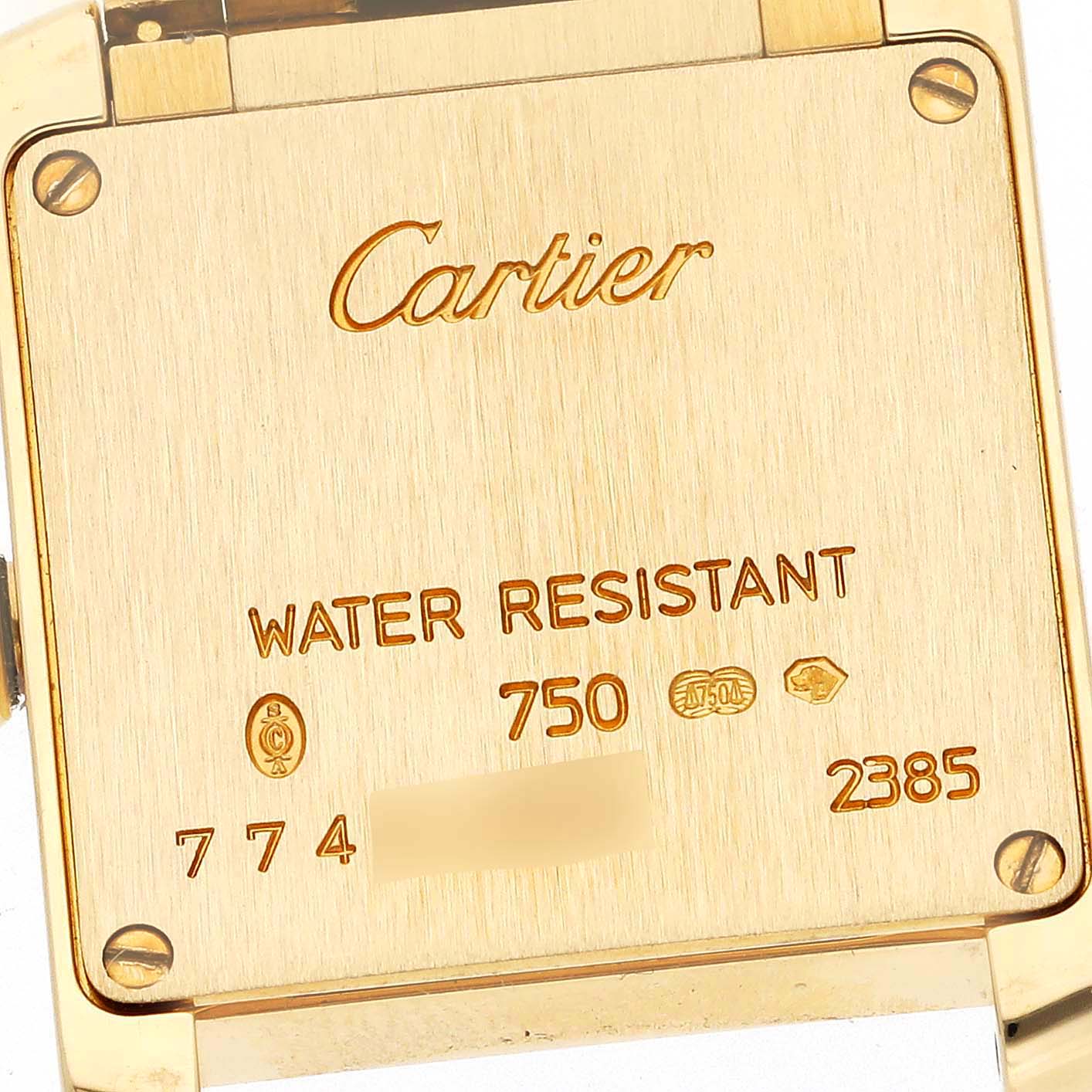 The image shows a close-up of the back case of a Cartier Tank Francaise WE1001R8 Women's Yellow Gold Silver Dial WE1001R8 Women's Yellow Gold Silver Dial watch, detailing its water resistance and gold markings.