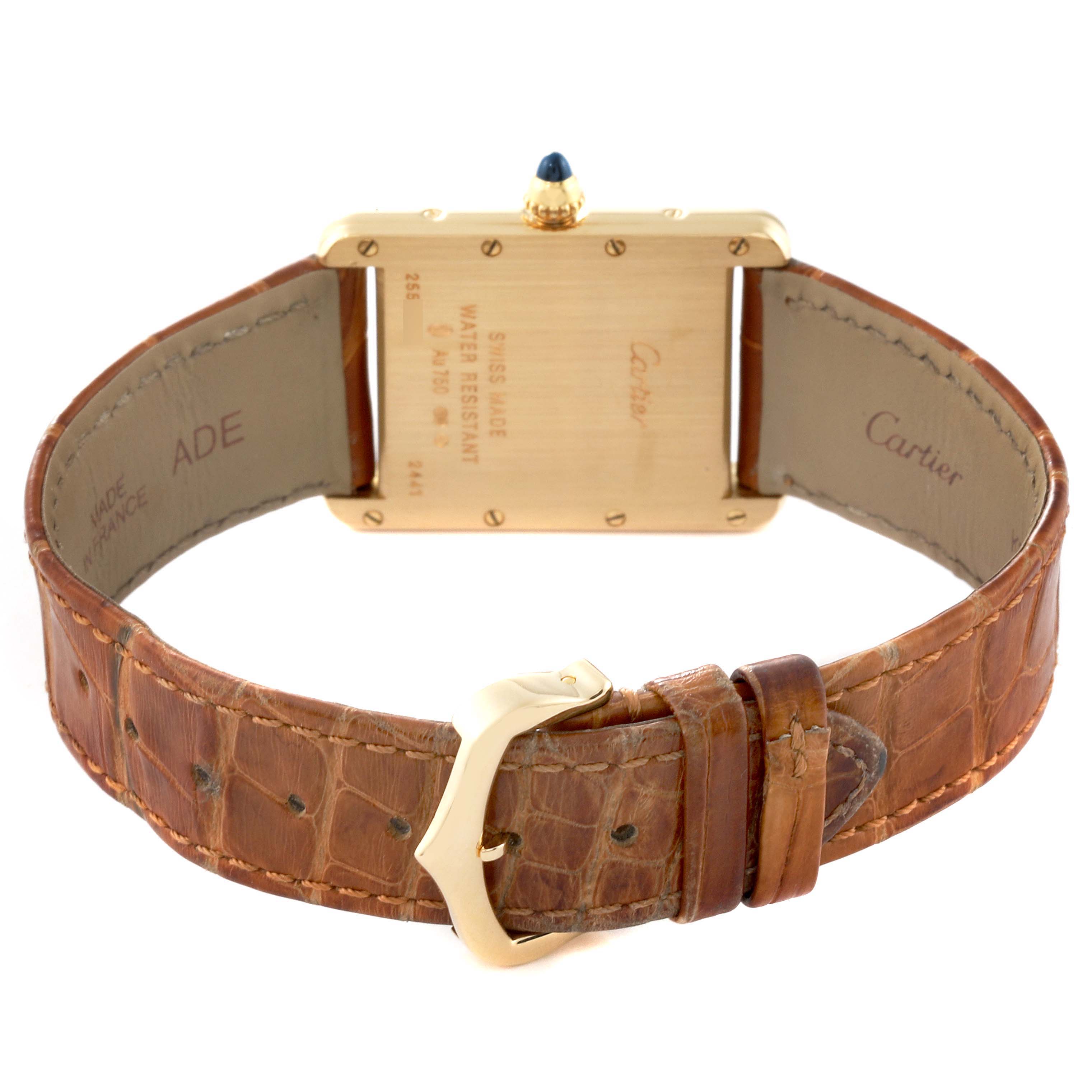 This image shows the back view of a Tank Louis model by Cartier, featuring the case back, crown, and leather strap with a buckle.