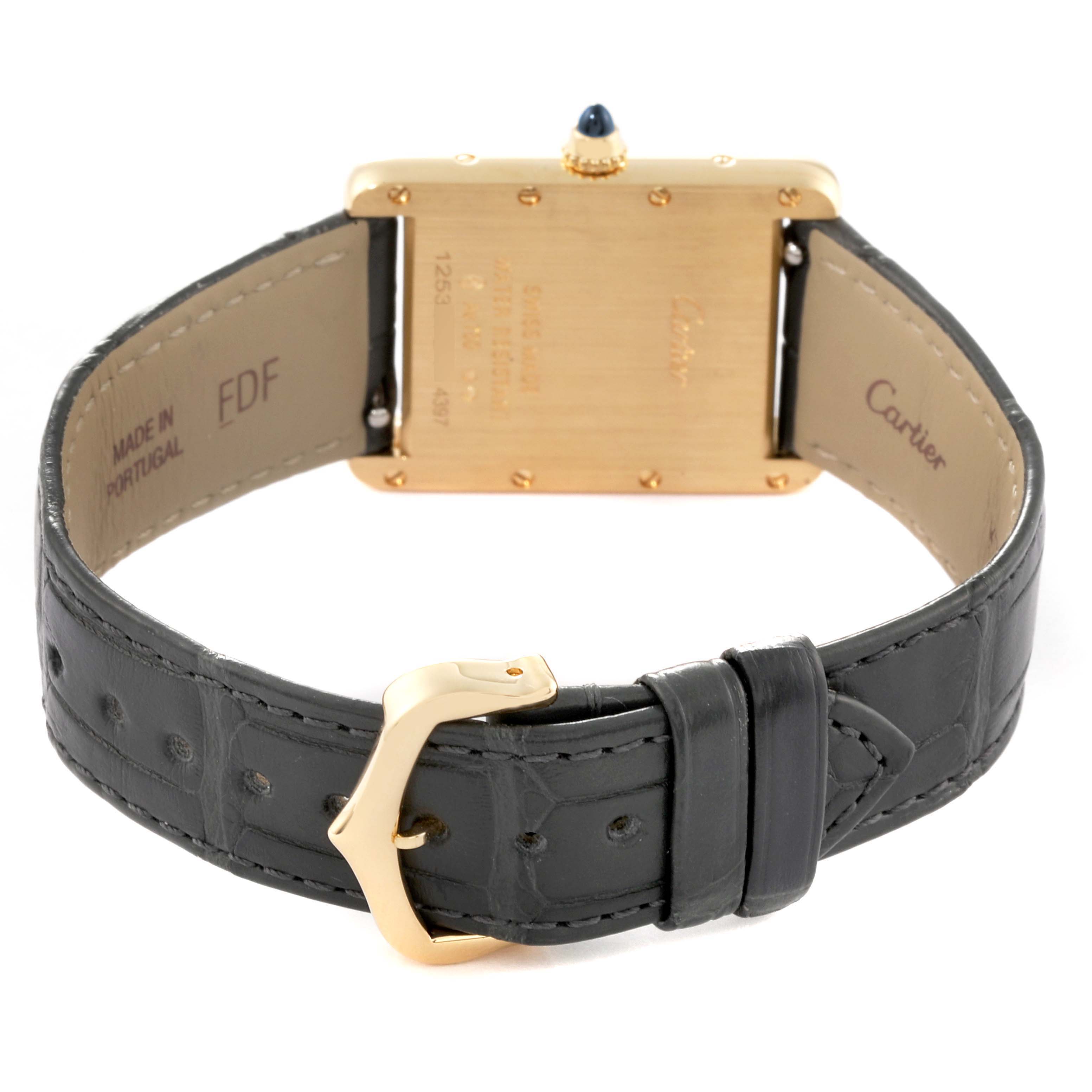 The image shows the back view of a Tank Louis model by Cartier, highlighting the case back, crown, and leather strap with buckle.