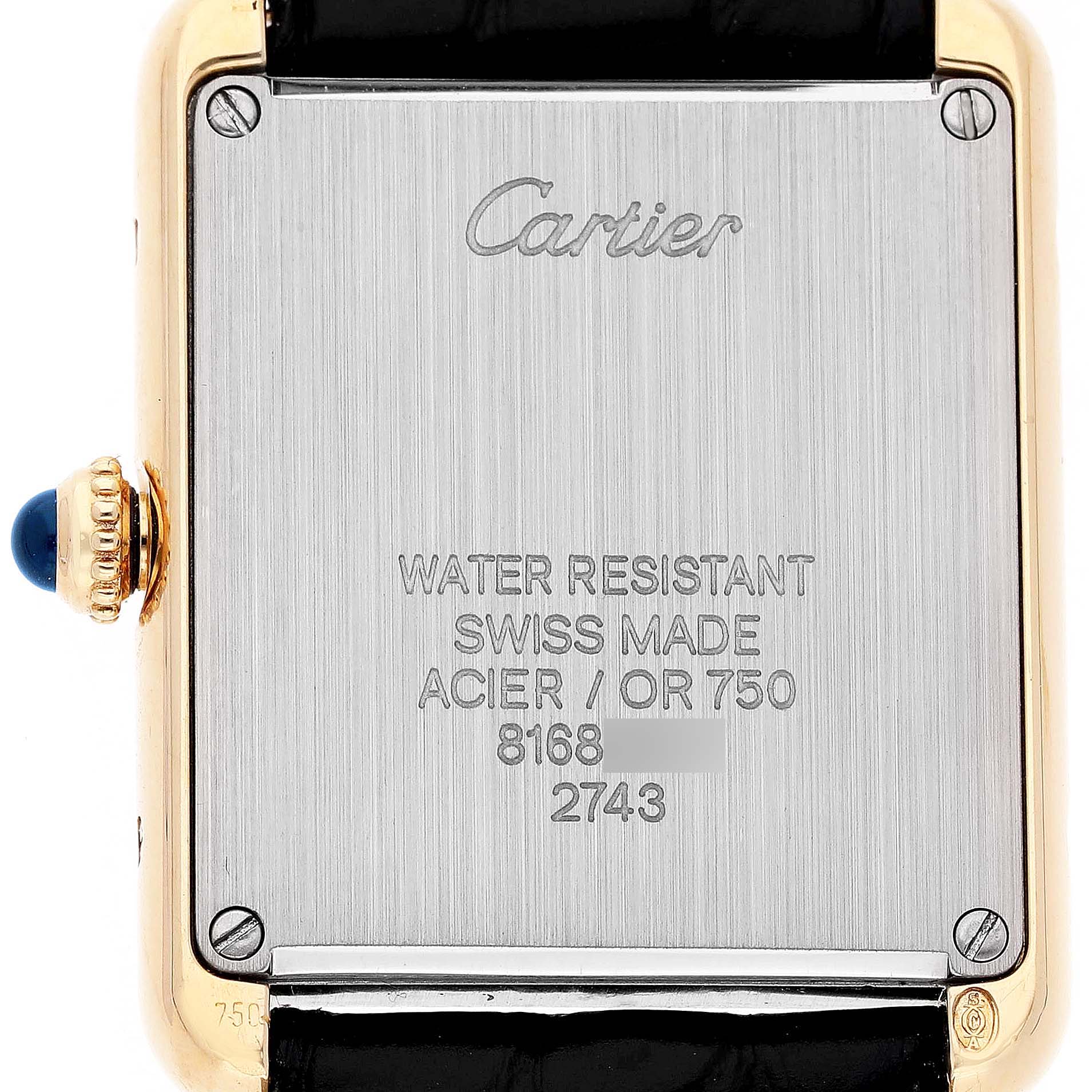 The image shows the back case of a Cartier Tank Solo W1018755 Women's Yellow Gold Silver Dial watch, highlighting its inscriptions and crown.