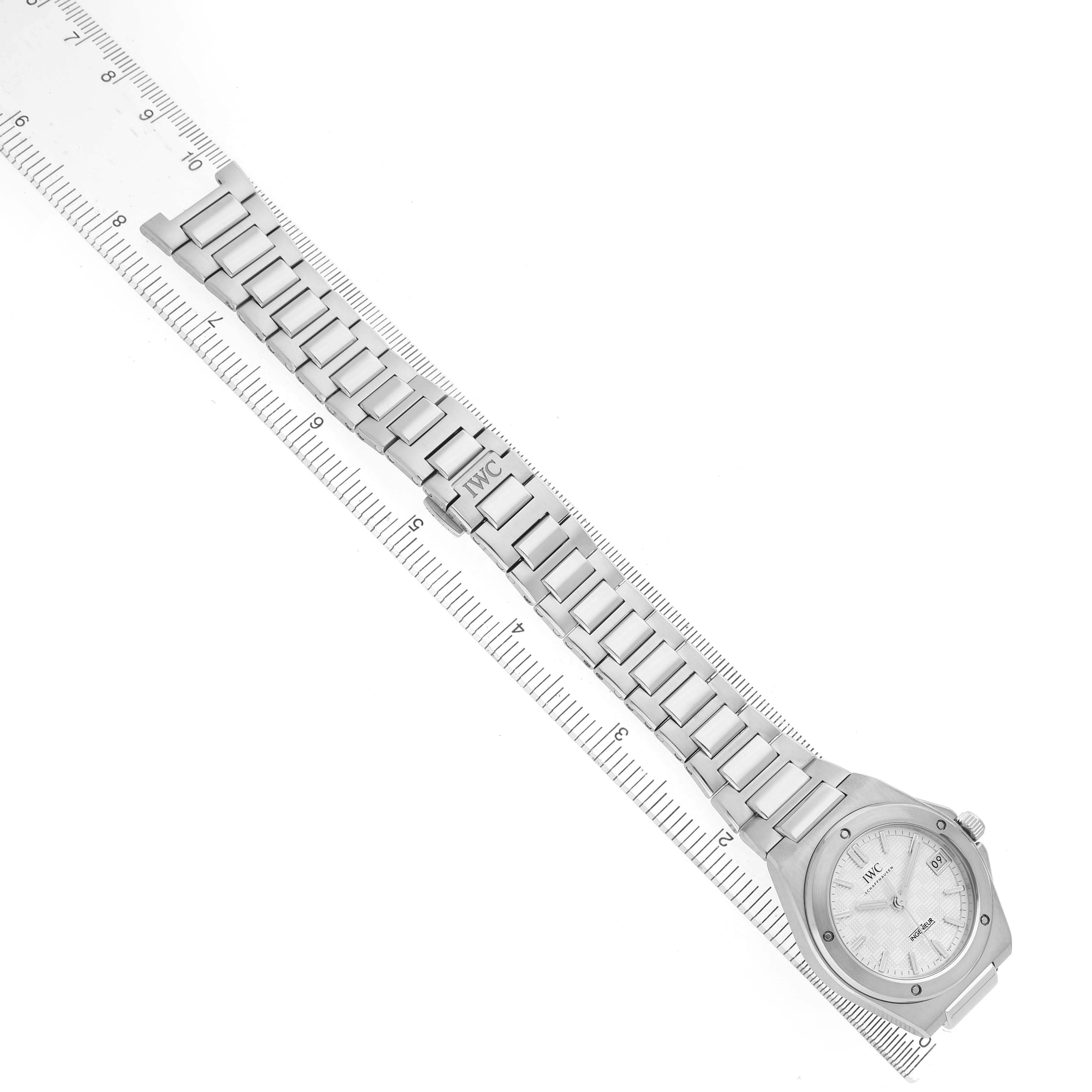 The IWC IW324901 Women's Stainless Steel Silver Dial Ingenieur 35 Steel Silver Dial Ladies Watch IW324901 is shown flat from above, displaying its bracelet and dial alongside a ruler.