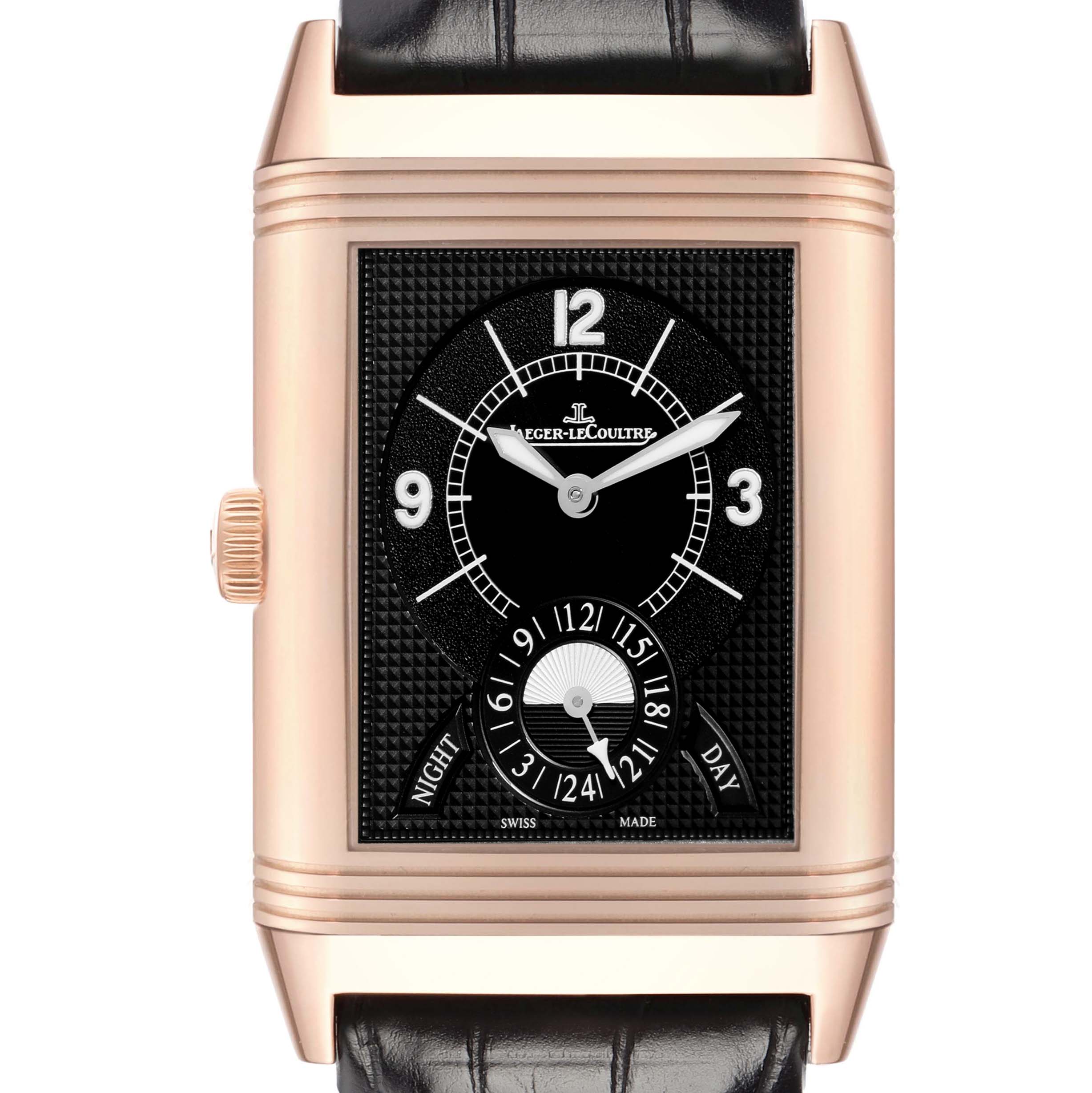 The Jaeger-LeCoultre Reverso watch is shown from the front, highlighting its gold case, black dial, and leather strap.