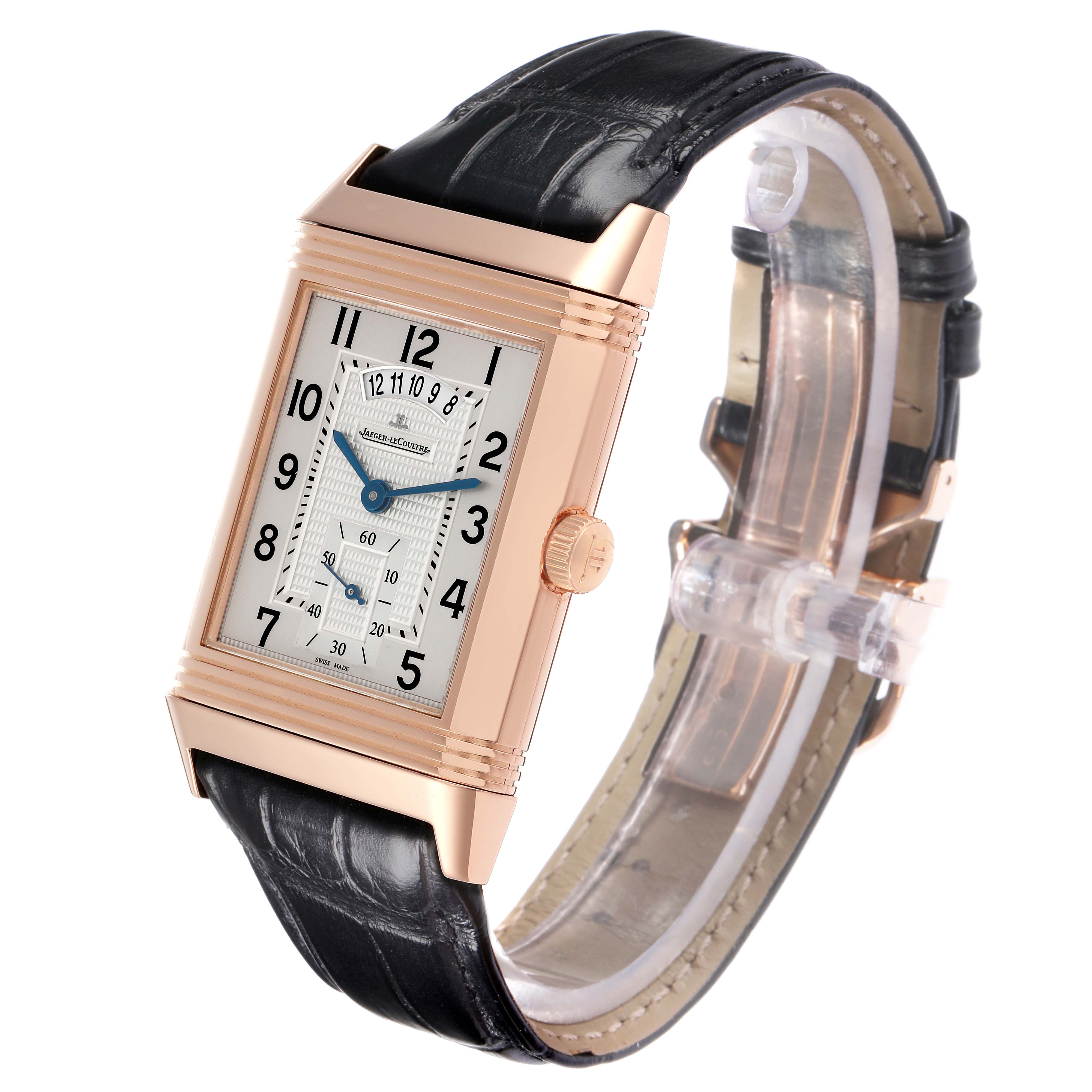 The Jaeger-LeCoultre Reverso watch is shown at a three-quarter angle, displaying its rectangular face, crown, and leather strap.
