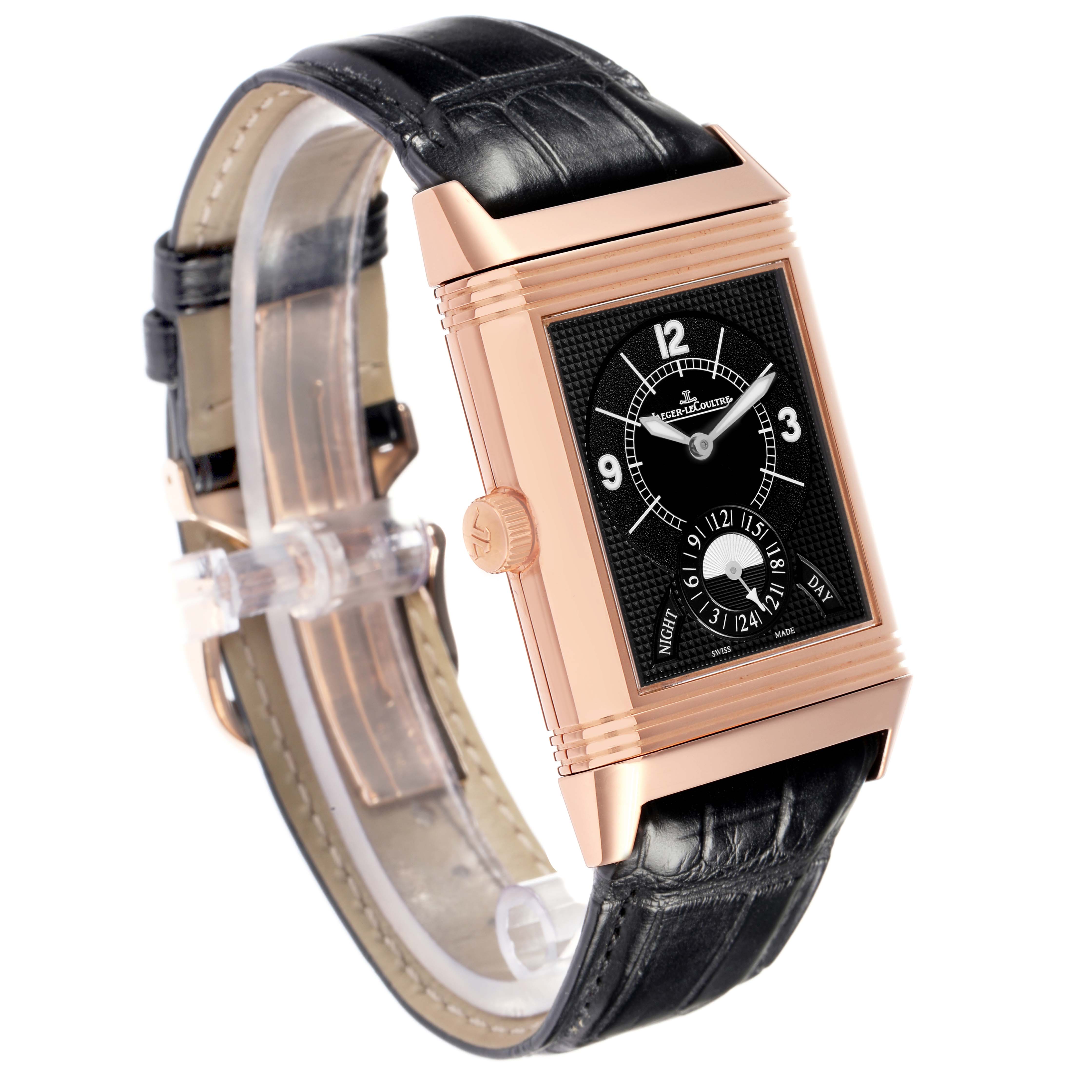 The Jaeger-LeCoultre Reverso watch is shown at a three-quarter angle, displaying the front face with its crown and leather strap.