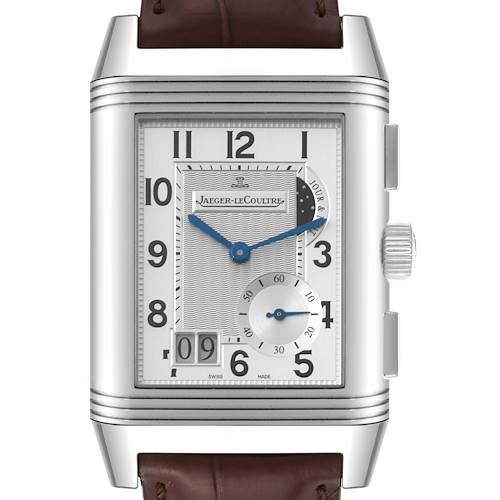 The Jaeger LeCoultre Reverso watch is shown up close on its face, displaying the dial, numerals, subdial, and crown.