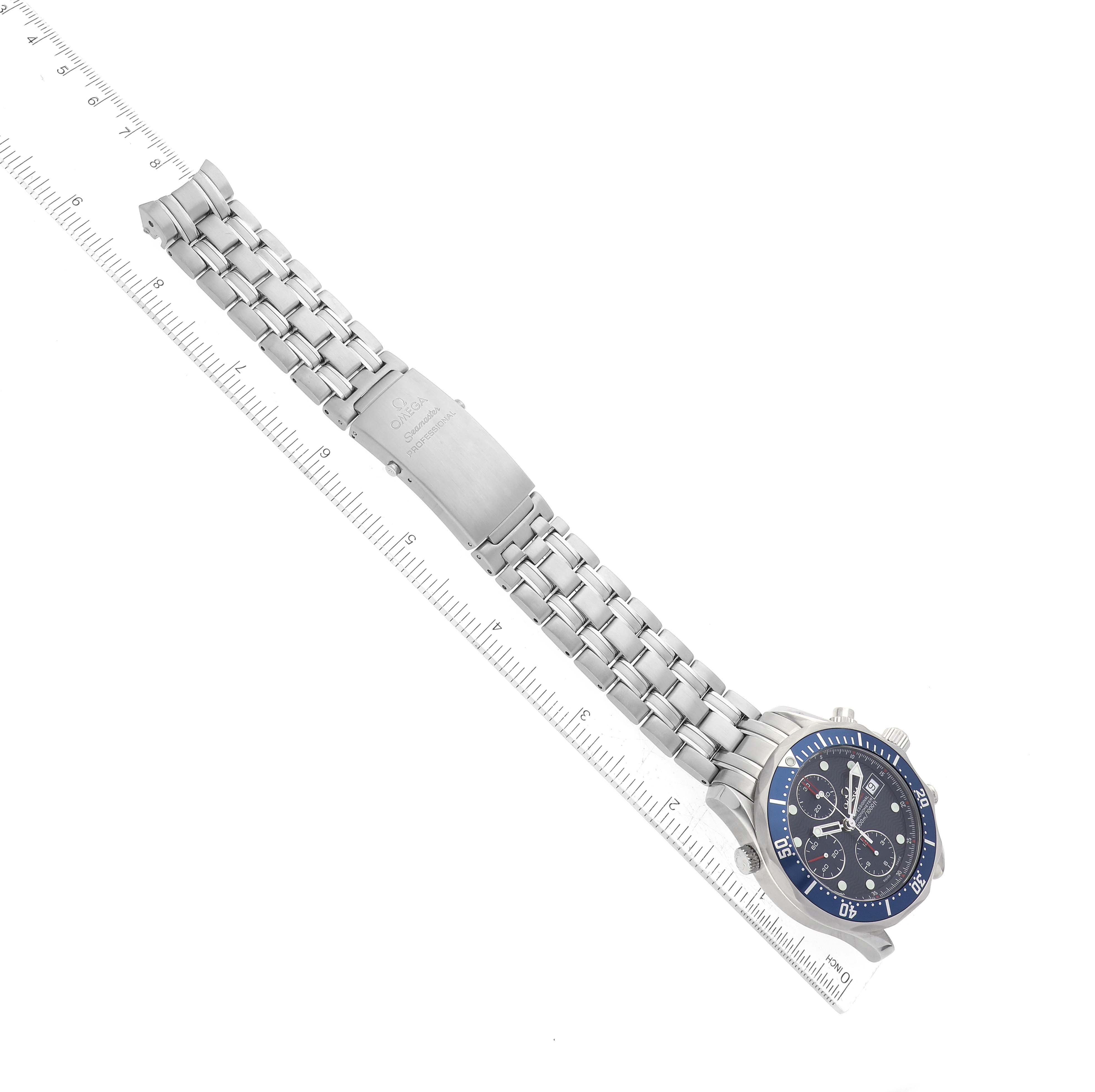 The image shows an Omega Seamaster 2225.80.00 Men
s Stainless Steel Blue Dial 2225.80.00 Men
s Stainless Steel Blue Dial watch laid flat alongside a ruler, highlighting the watch face and metal bracelet.