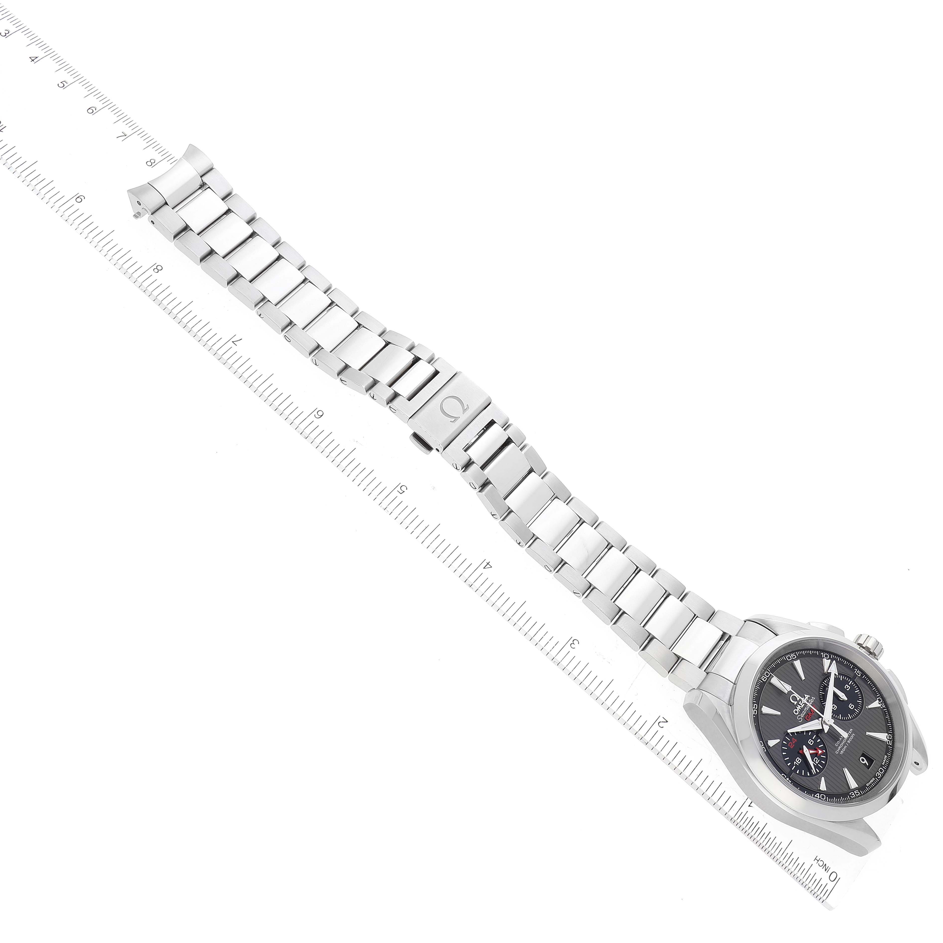 The Omega Aqua Terra 231.10.43.52.06.001 Men's Stainless Steel Grey Dial watch is angled to show the face, bracelet, and clasp, with a ruler for scale.