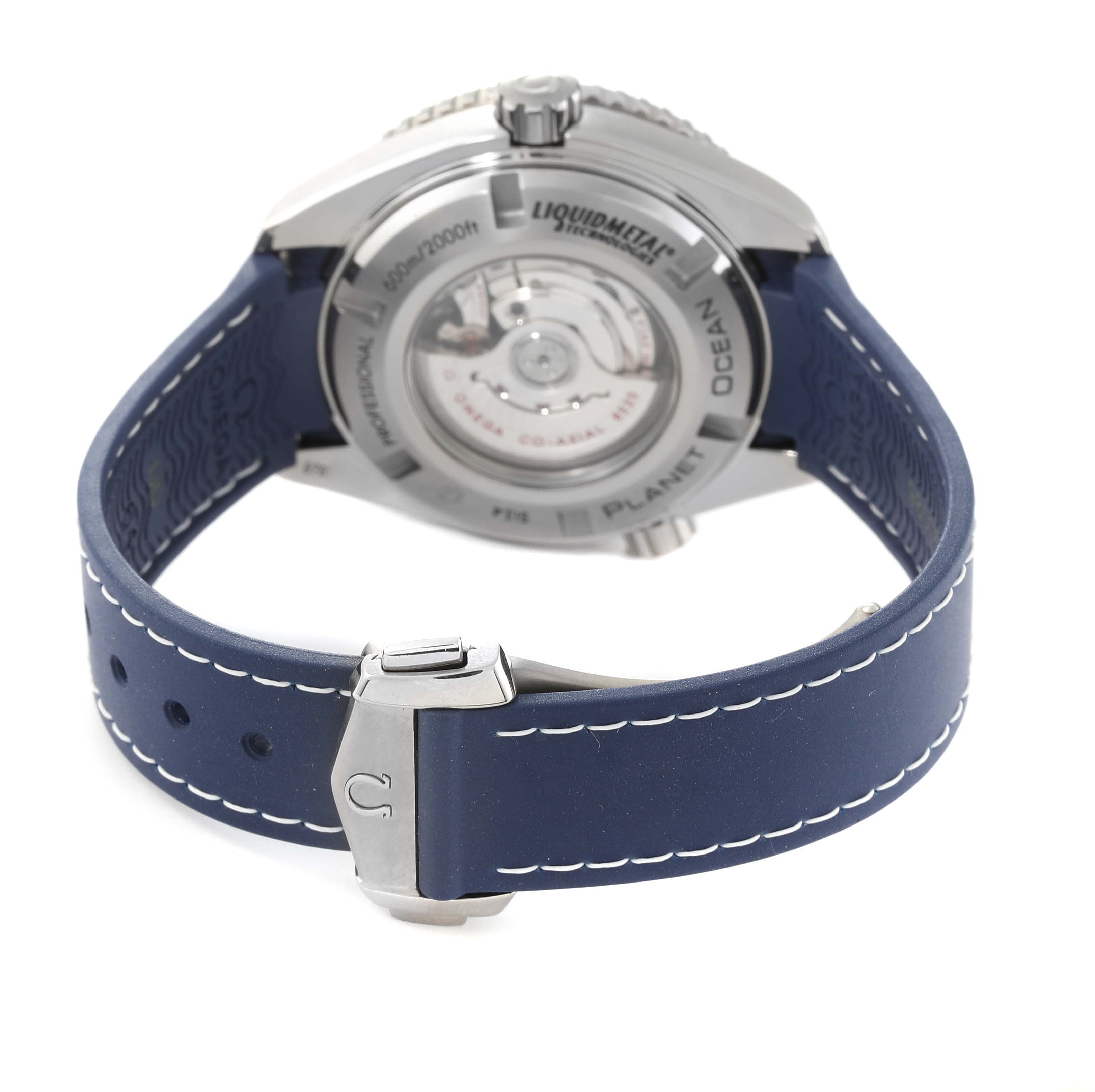 This Omega Planet Ocean 232.92.38.20.03.001 Men
s Titanium Blue Dial 232.92.38.20.03.001 Men
s Titanium Blue Dial watch photo shows the back side, revealing the movement and blue strap with white stitching.