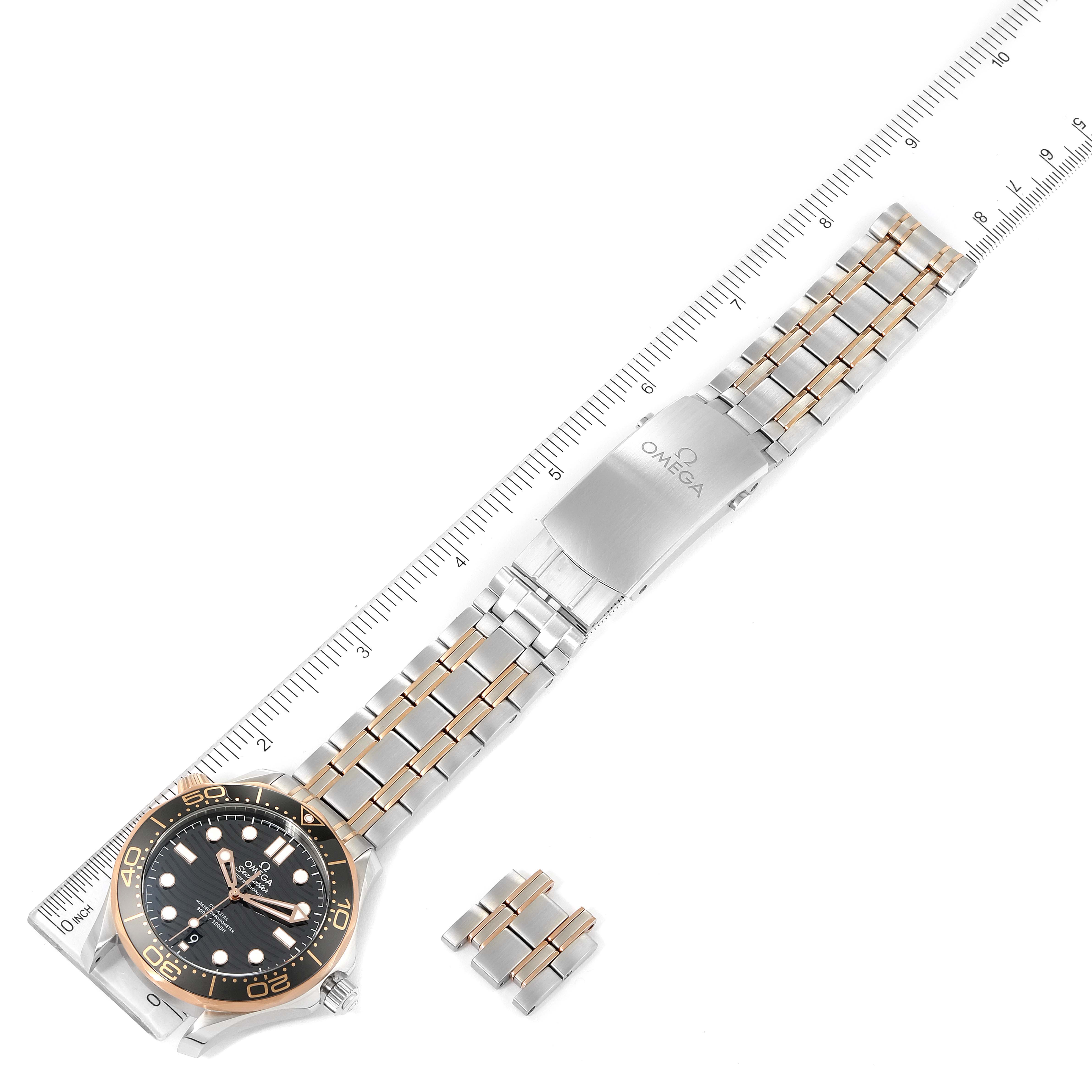 The Omega Seamaster 210.20.42.20.01.001 Men's Steel and Gold (two tone) Black Dial 210.20.42.20.01.001 Men's Steel and Gold (two tone) Black Dial watch is shown from a top-down angle with bracelet links and a branded clasp visible.