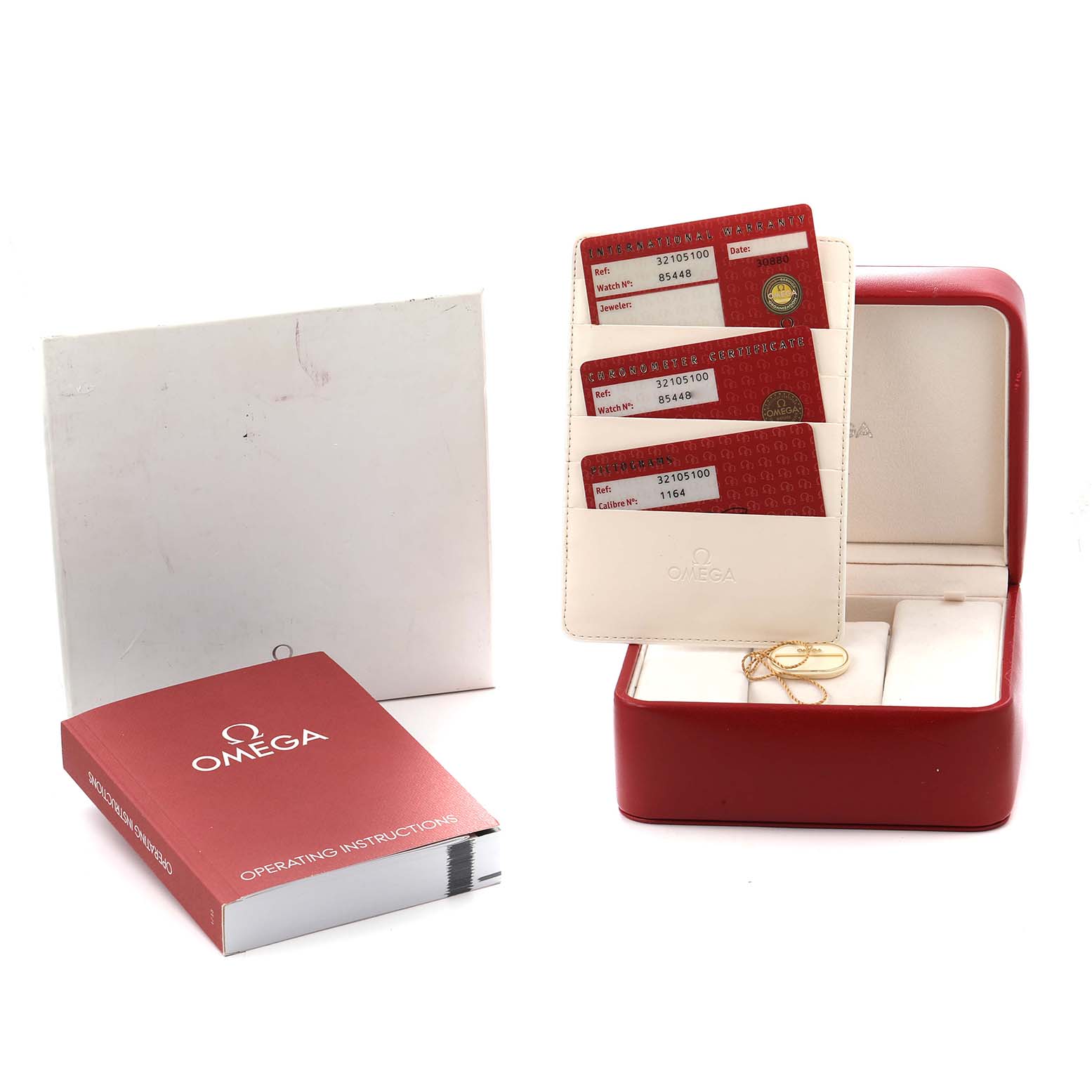 The image shows the Omega Speedmaster 3210.51.00 Men
s Stainless Steel Black Dial box, warranty cards, and operating instructions from a frontal angle.