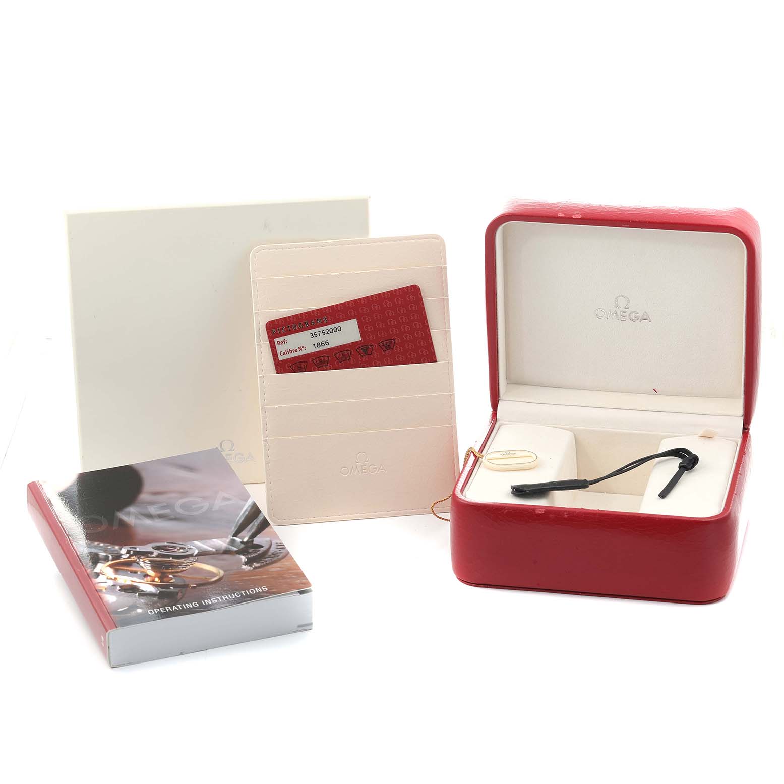 The image shows a red Omega box for a Speedmaster, a cardholder with a card, and an instruction manual.