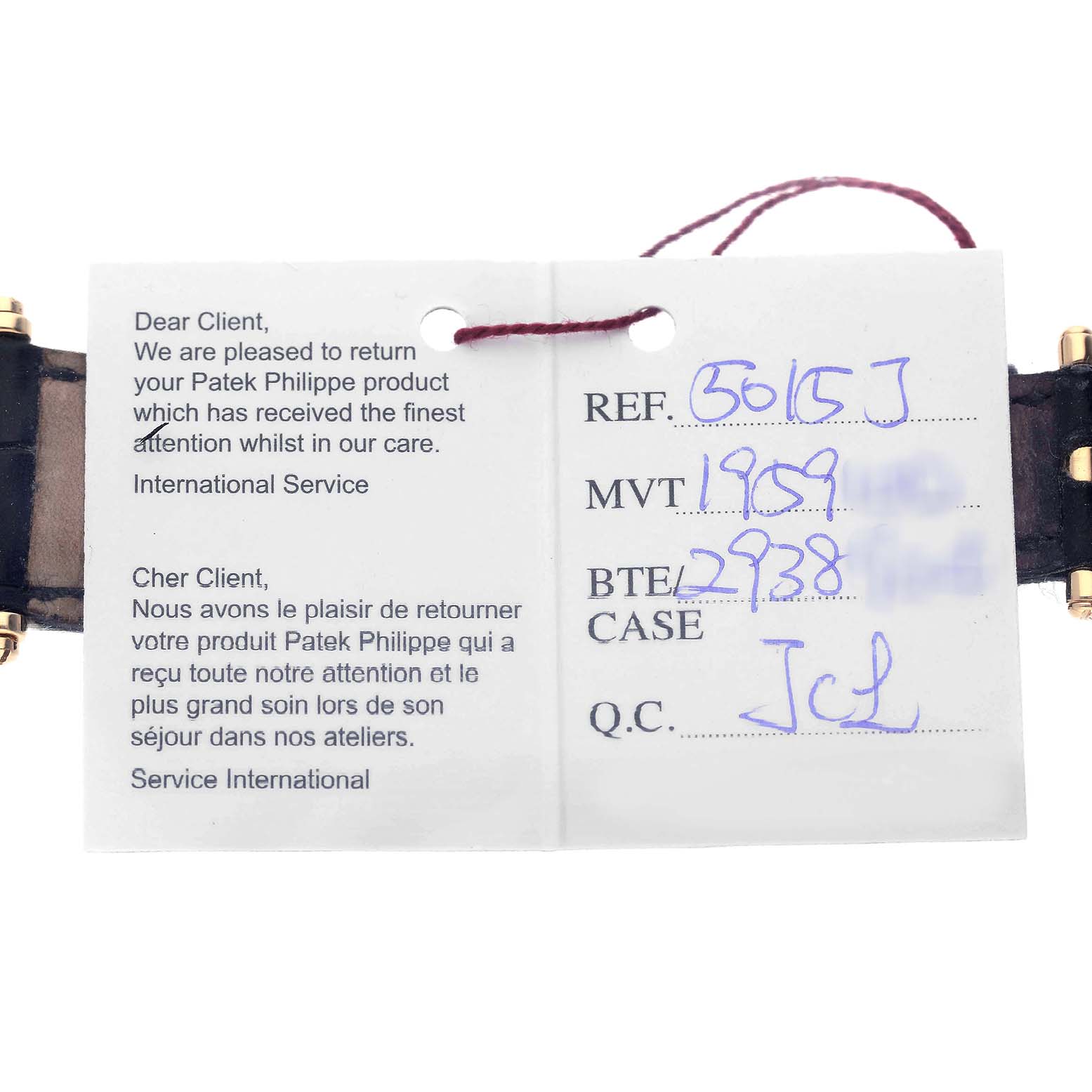 The image shows a service tag and parts of the strap and clasp of a Patek Philippe Calatrava 5015J-001 Men's Yellow Gold White Dial watch.