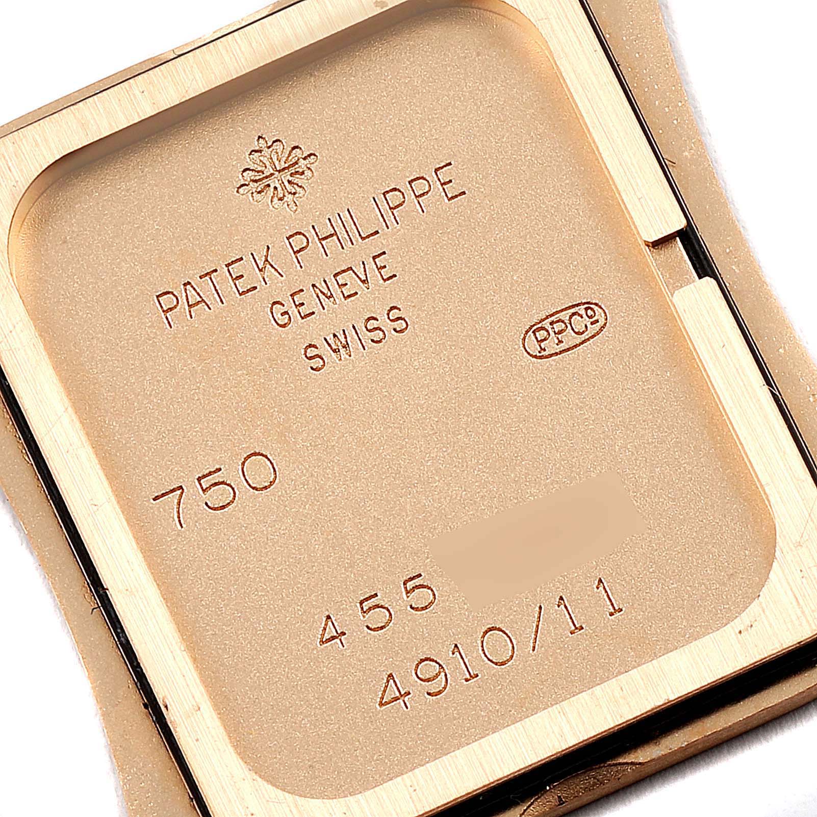 The image shows the back case of a Patek Philippe Twenty-4 4910/11R Women's Rose Gold Brown Dial 4910/11R Women's Rose Gold Brown Dial watch, highlighting its engravings and model number.