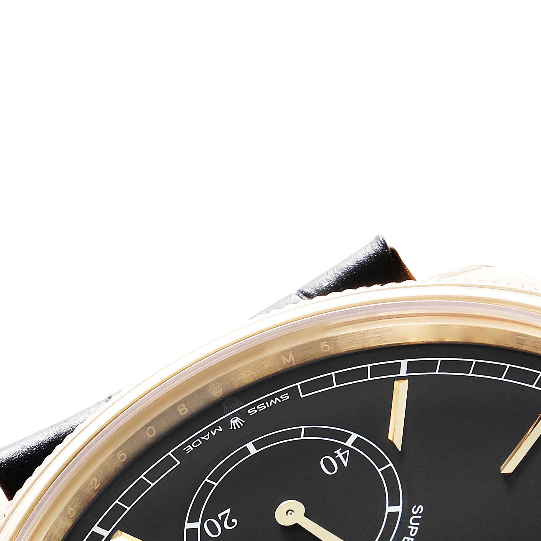 The image shows a partial top view of the Rolex 1908 52508 Men
s Yellow Gold Black Dial model, highlighting the dial, case, and part of the strap.