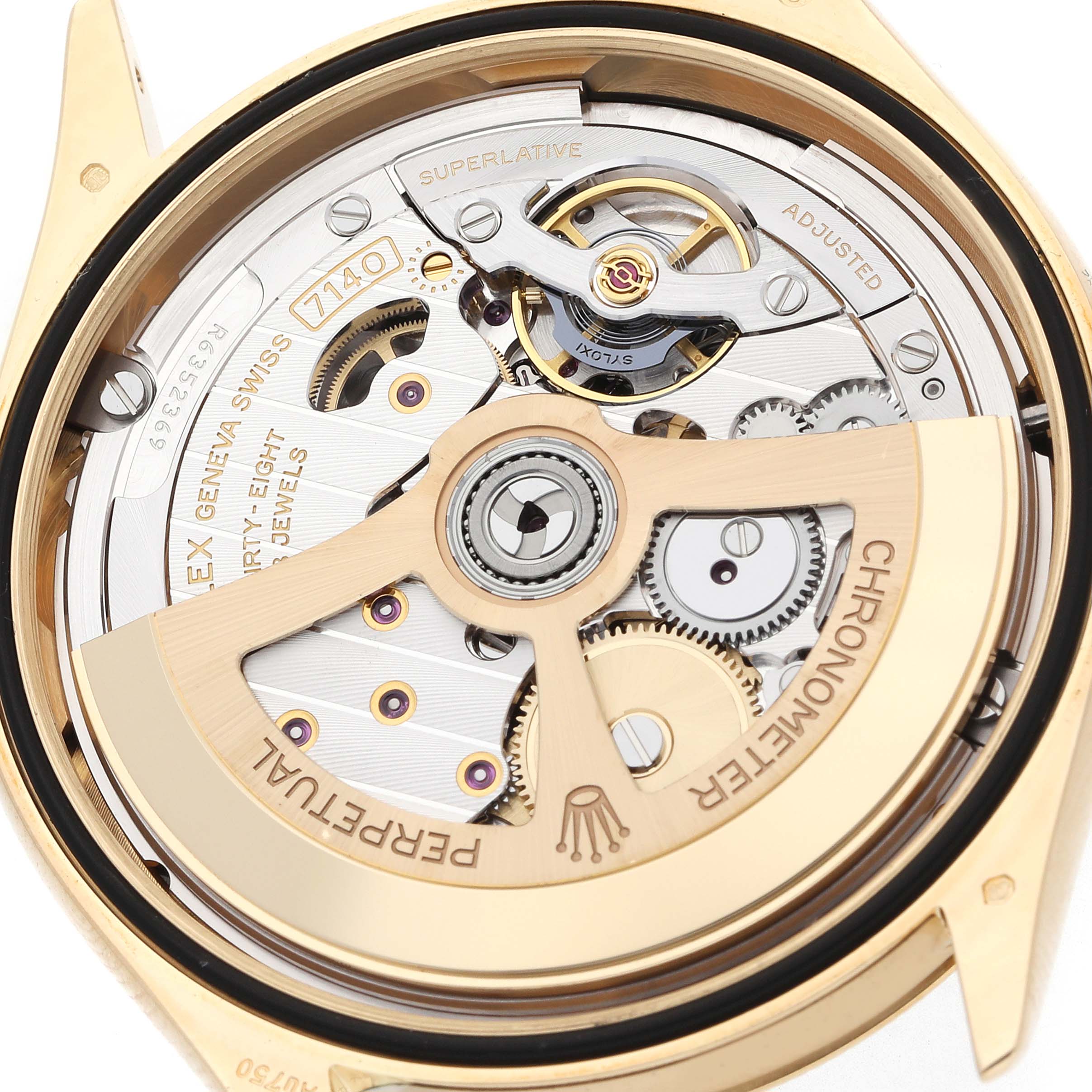 The image shows the back view of the Rolex 1908 52508 Men
s Yellow Gold Black Dial model, revealing its intricate mechanical movement and rotor.