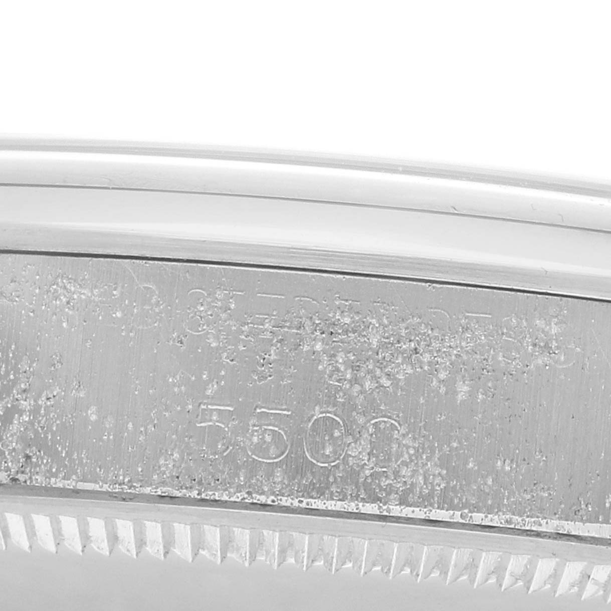The image shows a close-up of the side engraving details on the bezel of the Rolex Vintage Collection 5500 Men
s Stainless Steel Silver Dial model.