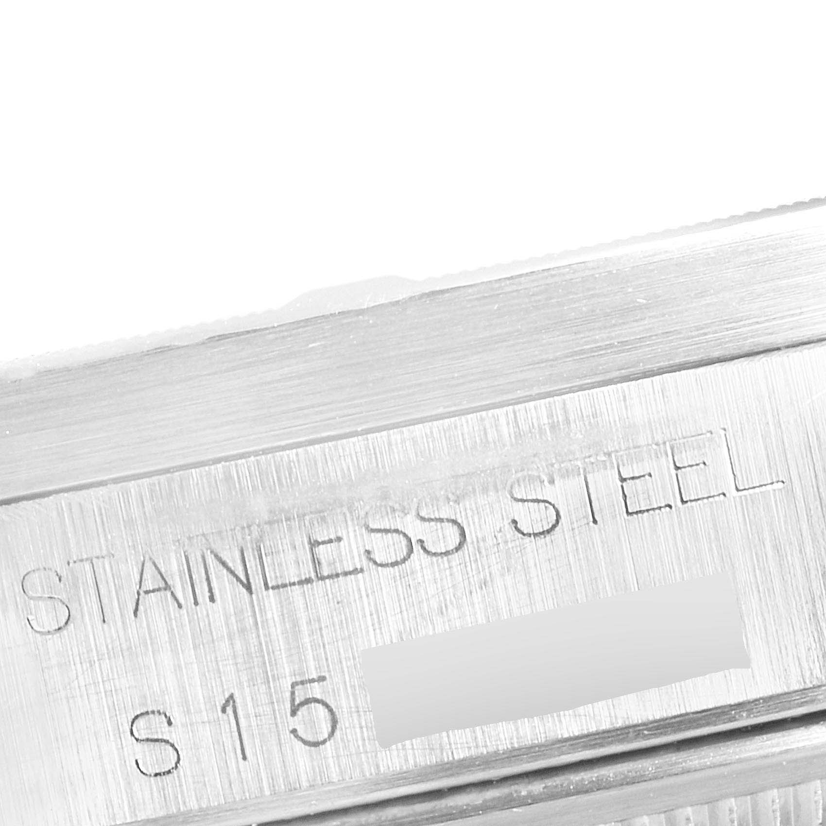 The image shows a close-up of the case back edge with "STAINLESS STEEL" engraved on a Rolex Date 15210 Men's Stainless Steel Grey Dial 15210 Men's Stainless Steel Grey Dial model watch.