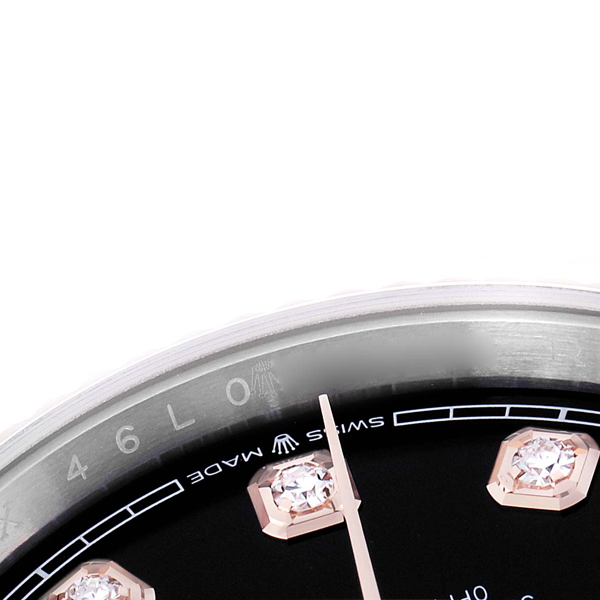 The image shows a close-up of the Rolex Datejust 126231 Men
s Steel and Gold (two tone) Black Dial watch dial with diamond markers, part of the bezel, and minute hand.
