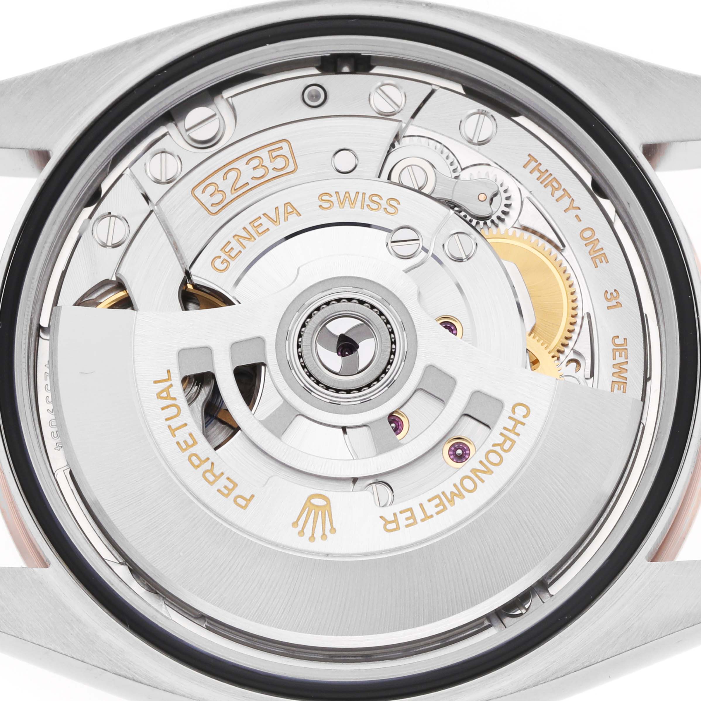 The image shows the back of a Rolex Datejust 126231 Men
s Steel and Gold (two tone) Black Dial, highlighting its intricate movement and mechanisms.