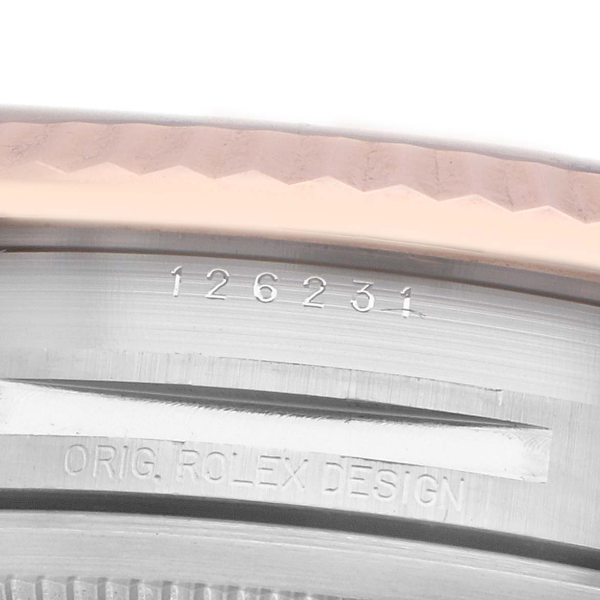 The image shows a close-up of the Rolex Datejust 126231 Men
s Steel and Gold (two tone) Brown Dial
s bezel and case side with engraved model numbers.