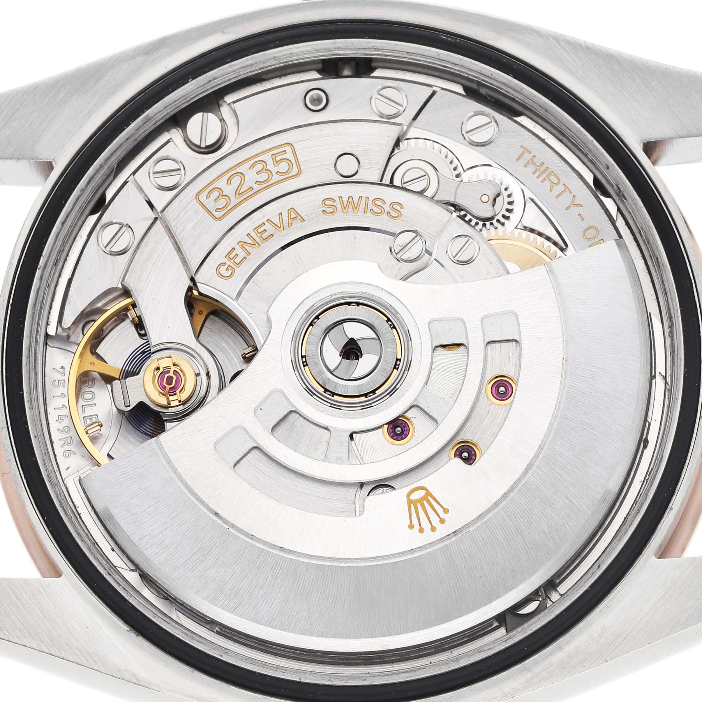 The image shows the back of a Rolex Datejust 126231 Men
s Steel and Gold (two tone) Brown Dial, highlighting the movement and intricate inner mechanics.