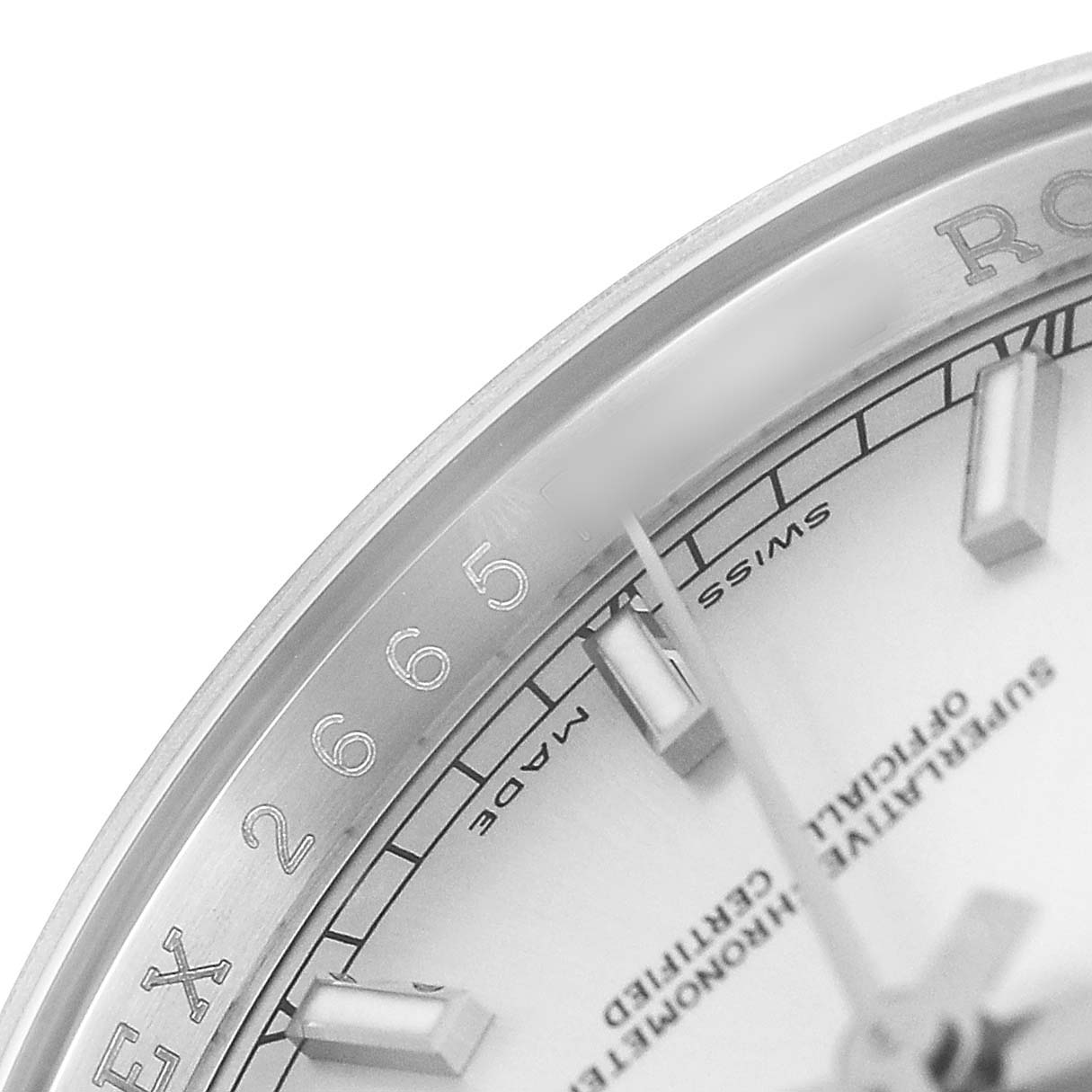 The image shows a close-up of the Rolex Datejust 116234 Men's Stainless Steel Silver Dial's dial and bezel, highlighting its index markers and partial text.