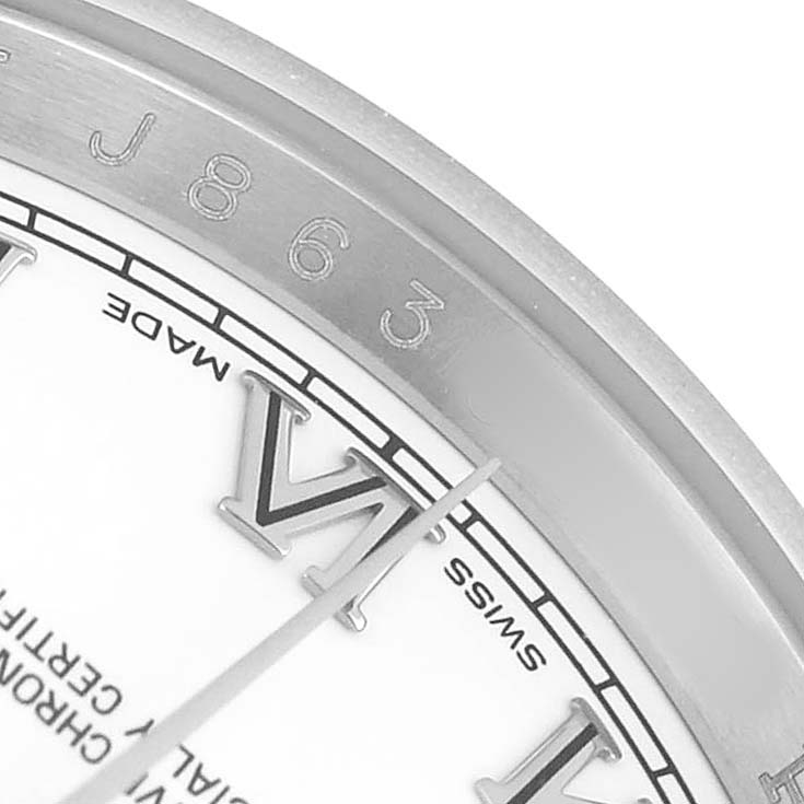 The image shows a close-up of a Rolex Datejust 116200 Men's Stainless Steel White Dial watch, focusing on the edge of the dial with Roman numerals and part of the bezel.