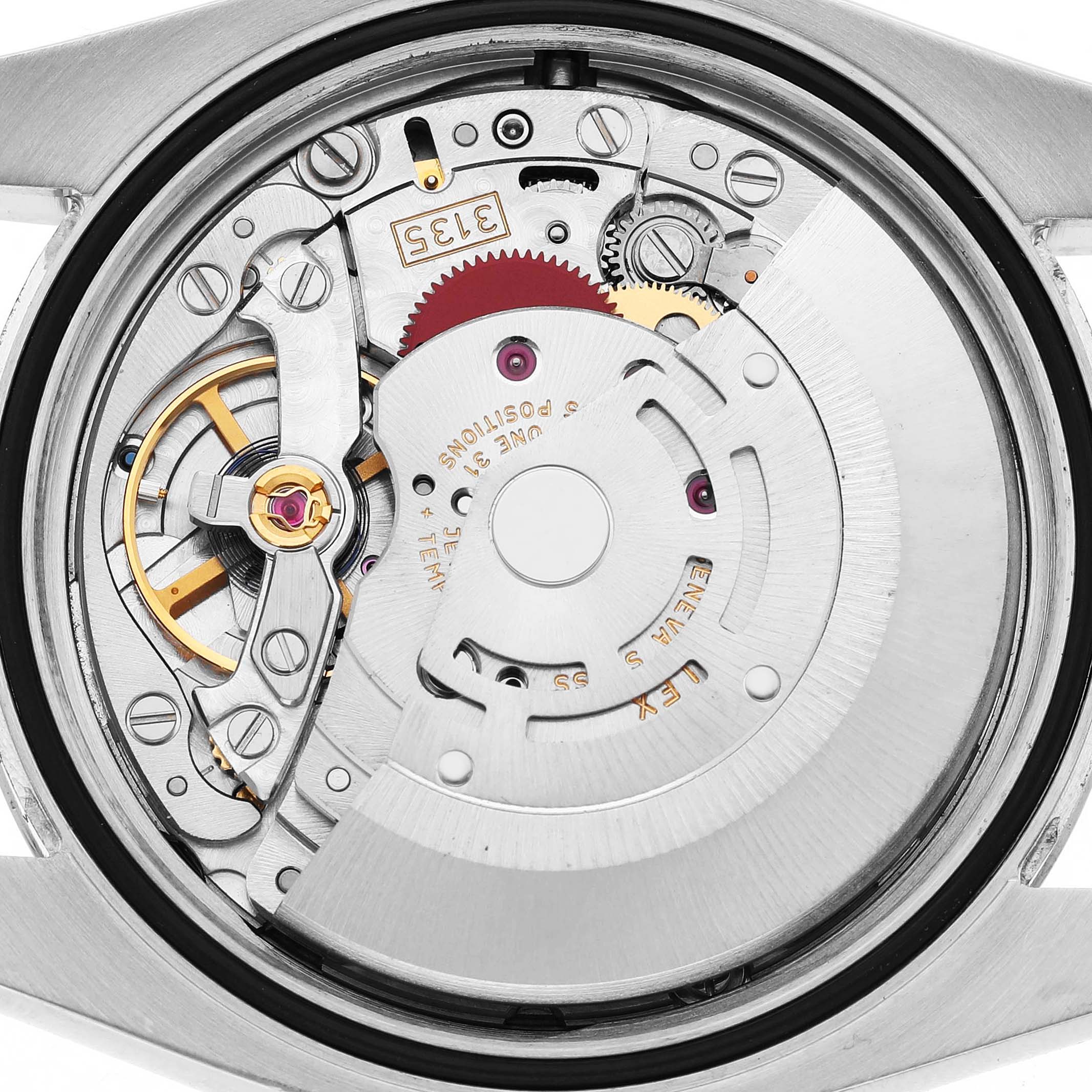 The image shows the inner mechanism of a Rolex Datejust 116200 Men's Stainless Steel White Dial, focusing on its movement and intricate components.
