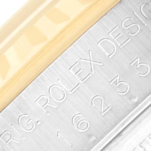 The image shows a close-up of the Rolex Datejust 16233 Men's Steel and Gold (two tone) Black Dial 16233 Men's Steel and Gold (two tone) Black Dial model, highlighting the engraved serial number and part of the bezel.