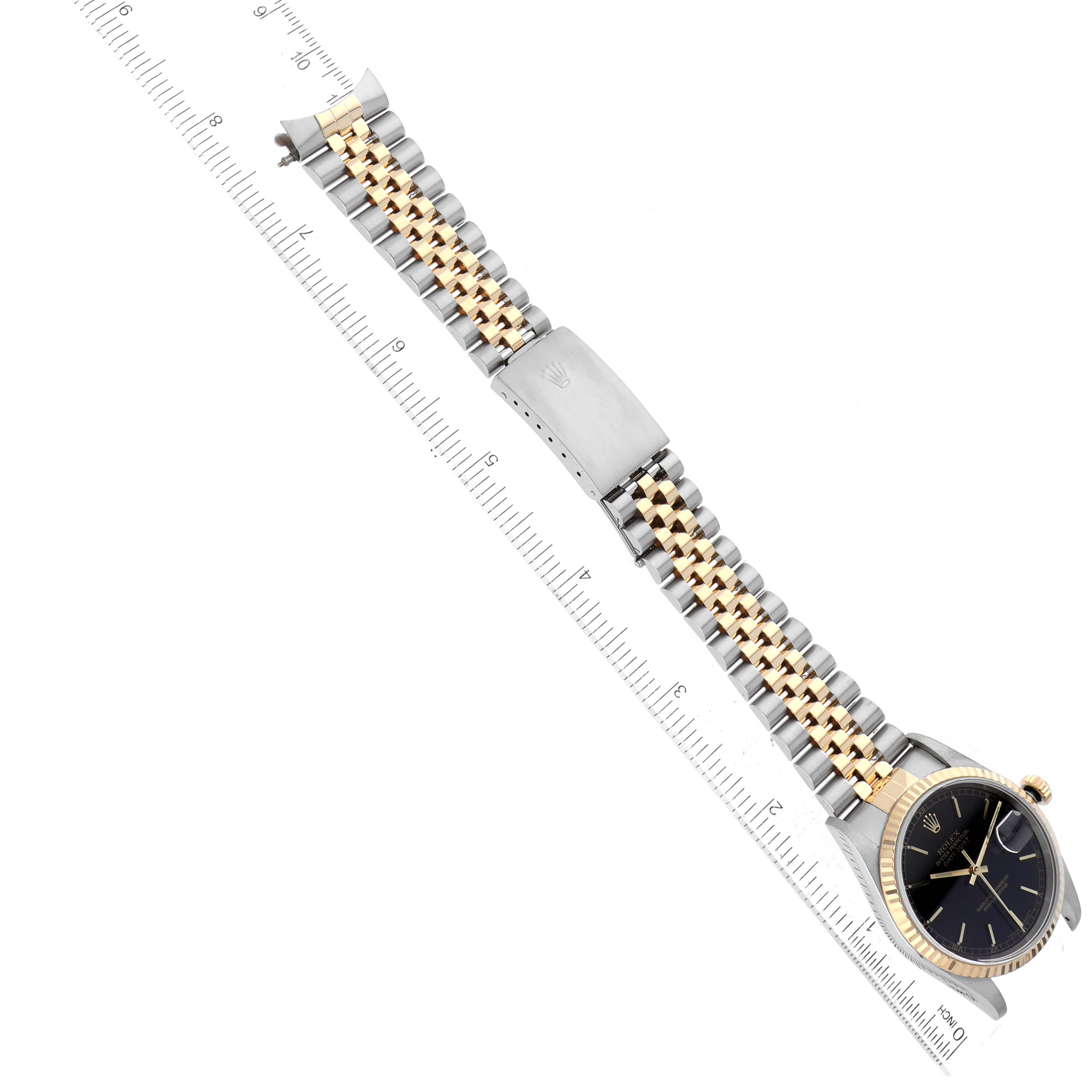 The image shows a Rolex Datejust 16233 Men's Steel and Gold (two tone) Black Dial 16233 Men's Steel and Gold (two tone) Black Dial watch from an oblique angle, featuring its bracelet, clasp, and black dial.