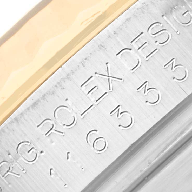 This close-up image shows part of the bezel and engraved lettering on the side of the Rolex Datejust 41 116333 Men's Steel and Gold (two tone) Black Dial 116333 Men's Steel and Gold (two tone) Black Dial model.