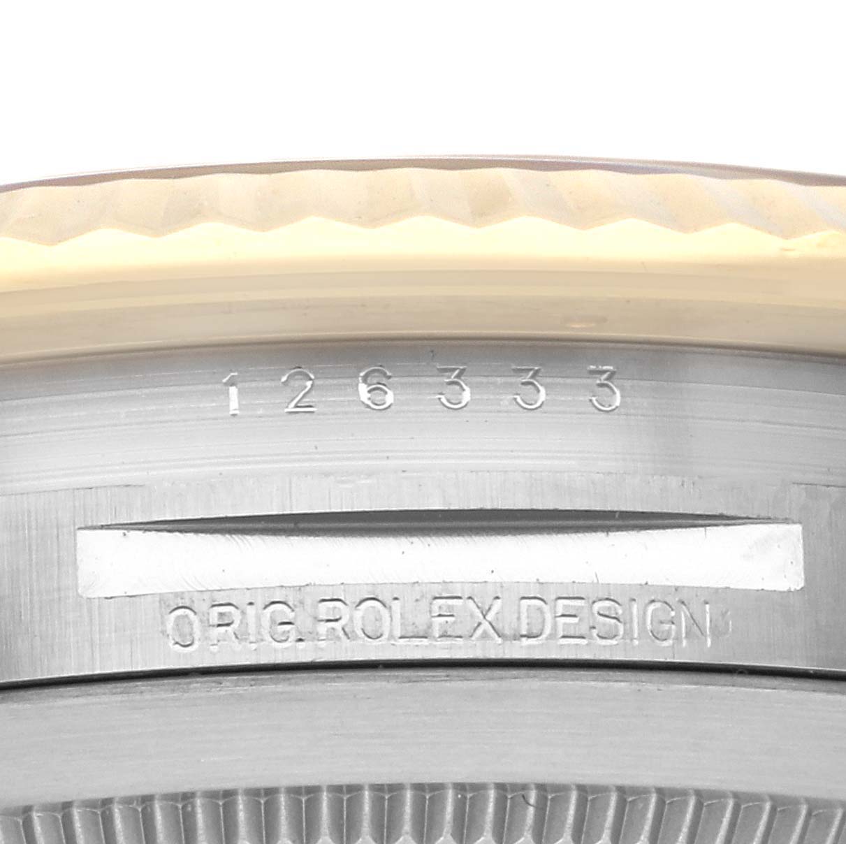 This image shows a close-up of the serial number and "ORIG. ROLEX DESIGN" engraving on the side of the case of a Rolex Datejust 41 126333 Men's Steel and Gold (two tone) Black Dial 126333 Men's Steel and Gold (two tone) Black Dial model.