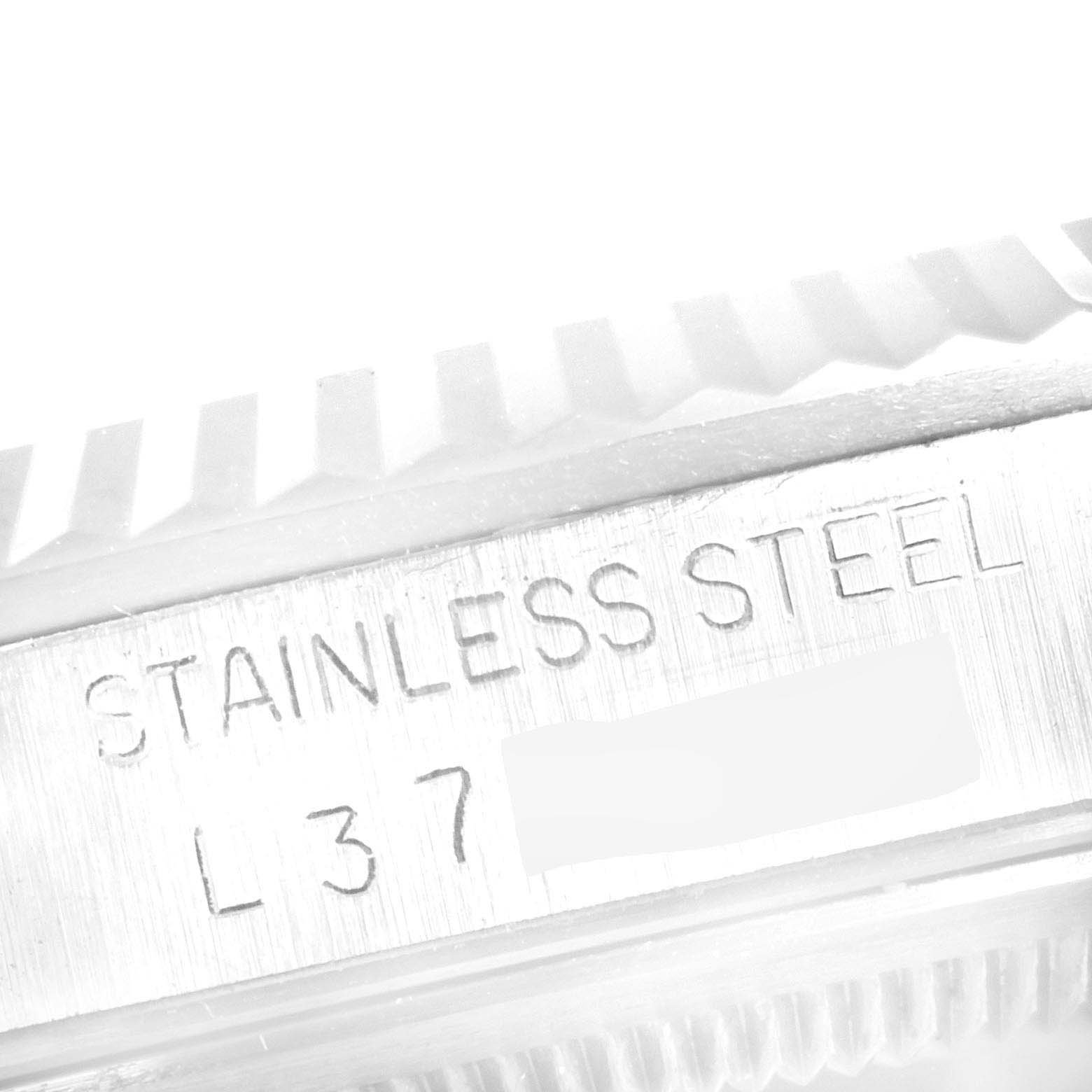 The image shows a close-up of the stainless steel marking on a Rolex Datejust 16234 Men's Stainless Steel Silver Dial 16234 Men's Stainless Steel Silver Dial watch, with part of the bezel visible.