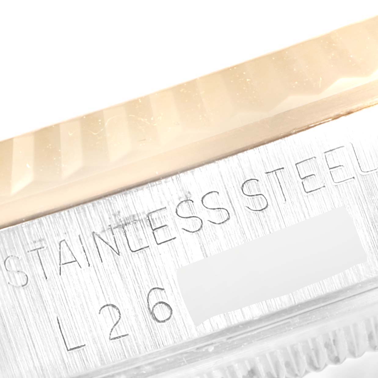 This image shows the brushed stainless steel side and the engraved details of a Rolex Datejust 16233 Men
s Steel and Gold (two tone) Champagne Dial 16233 Men
s Steel and Gold (two tone) Champagne Dial model.